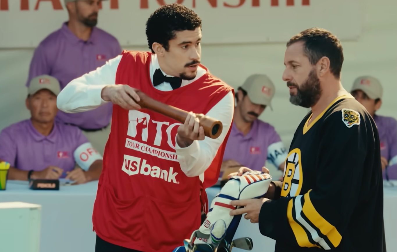 A man holding a pepper grinder next to Adam Sandler in Happy Gilmore 2.