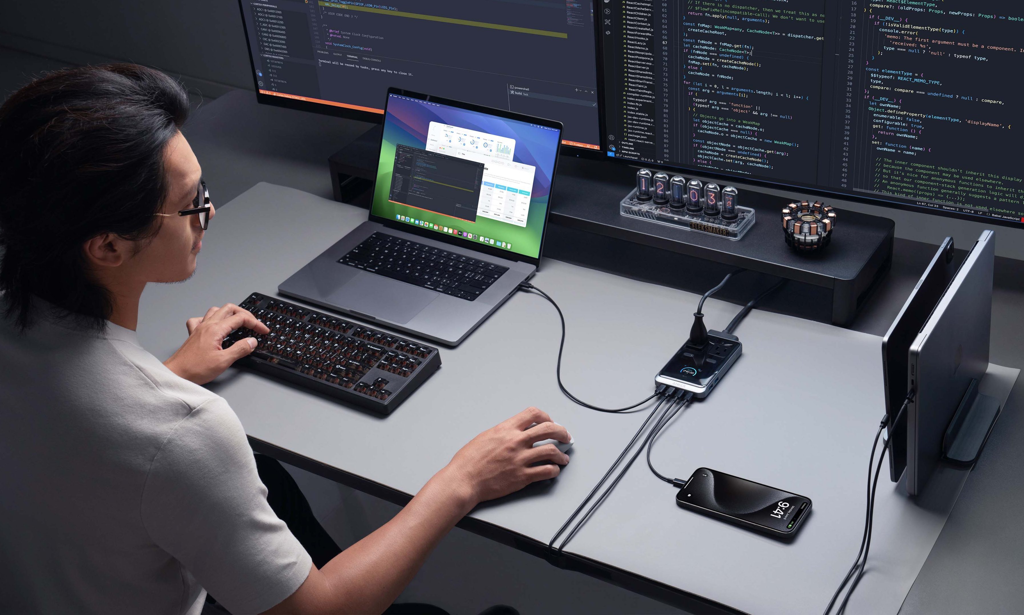 A man at a laptop with an Anker Prime Charging Station.