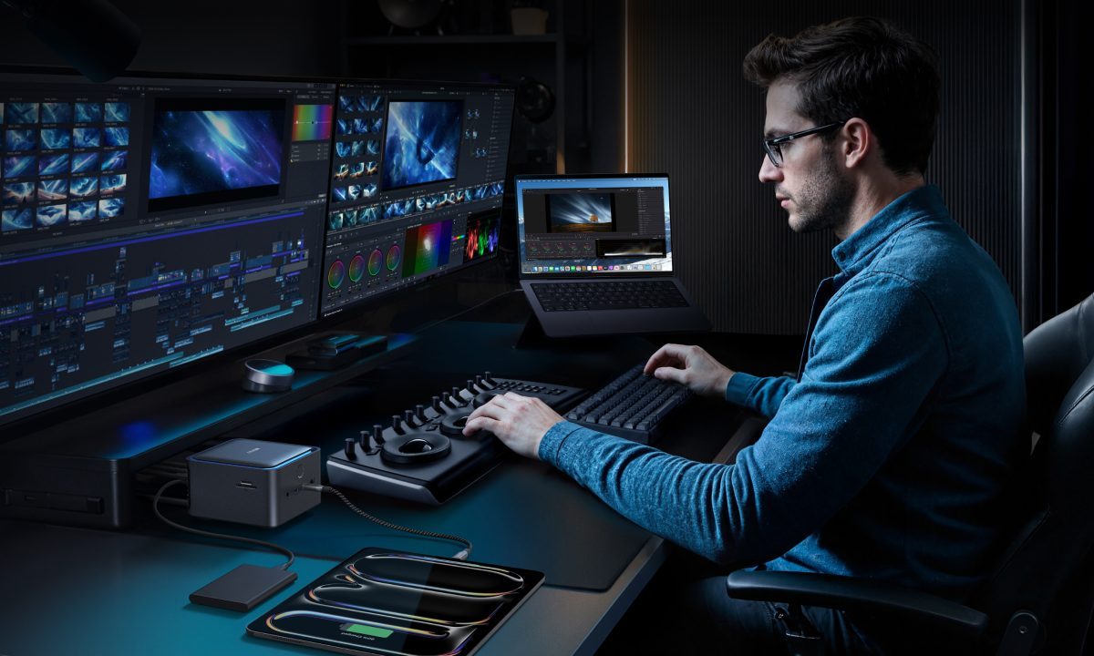 A man at a workstation with an Anker Prime Docking Station.