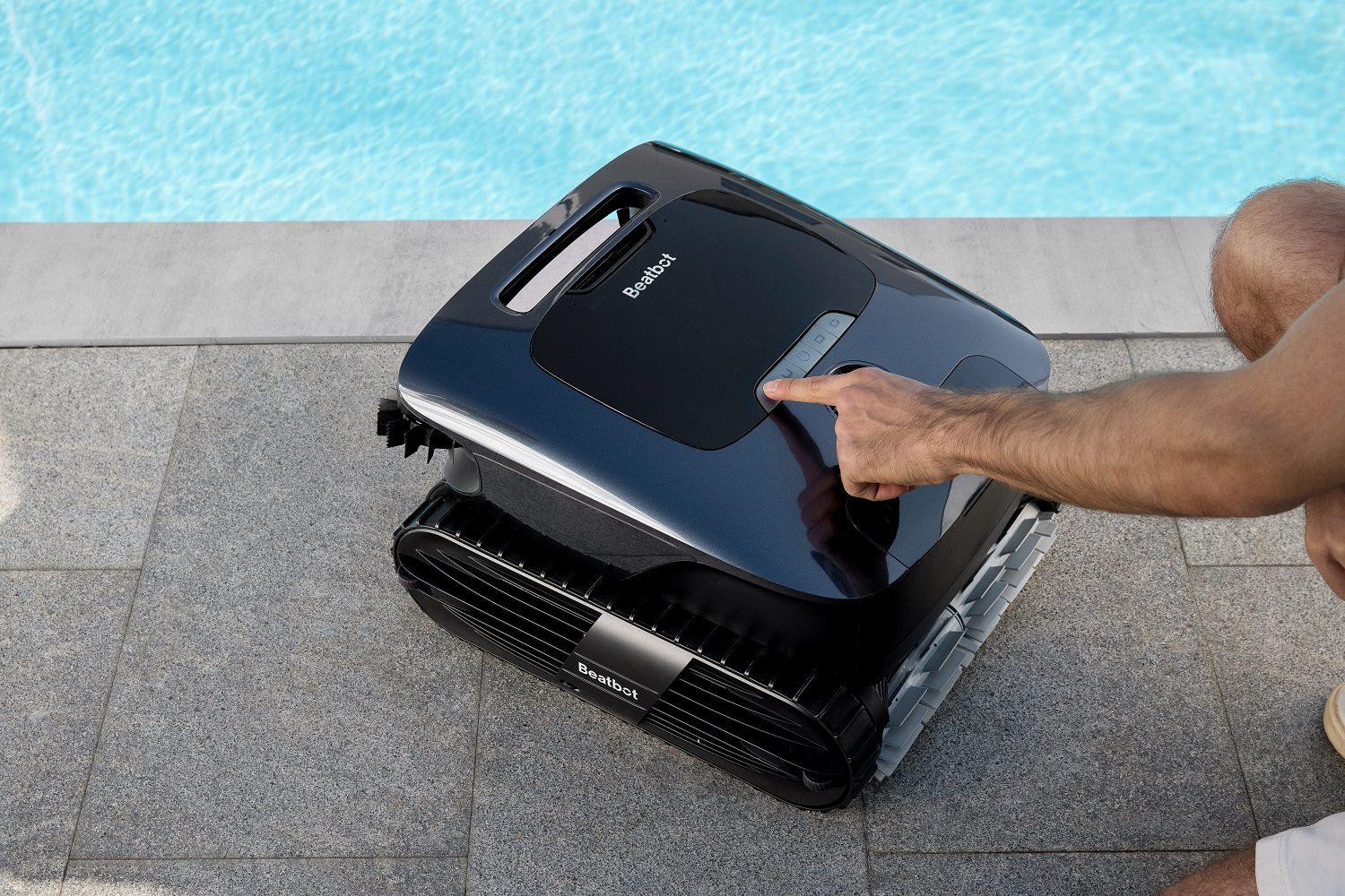 A person pressing a button on the Beatbot Aquasense 2 Ultra.