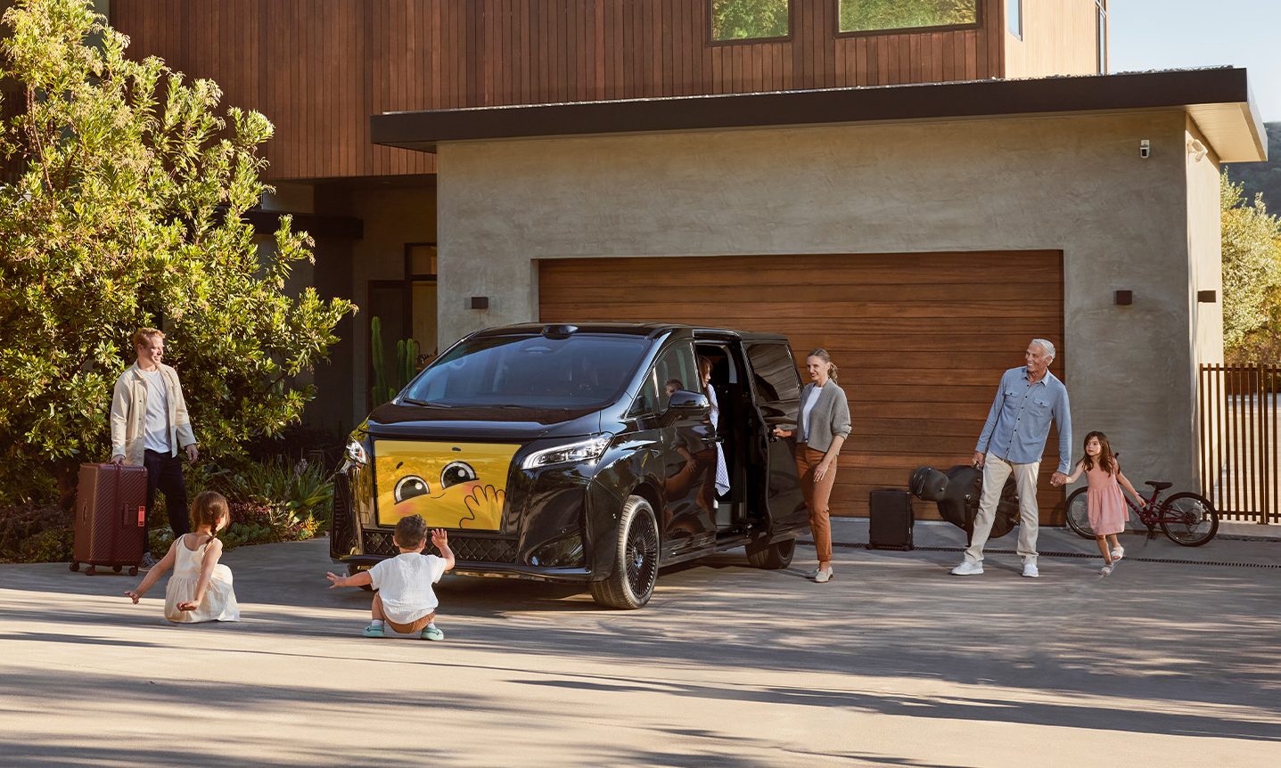 The Faraday FX Super One on a driveway, with a family surrounding the car