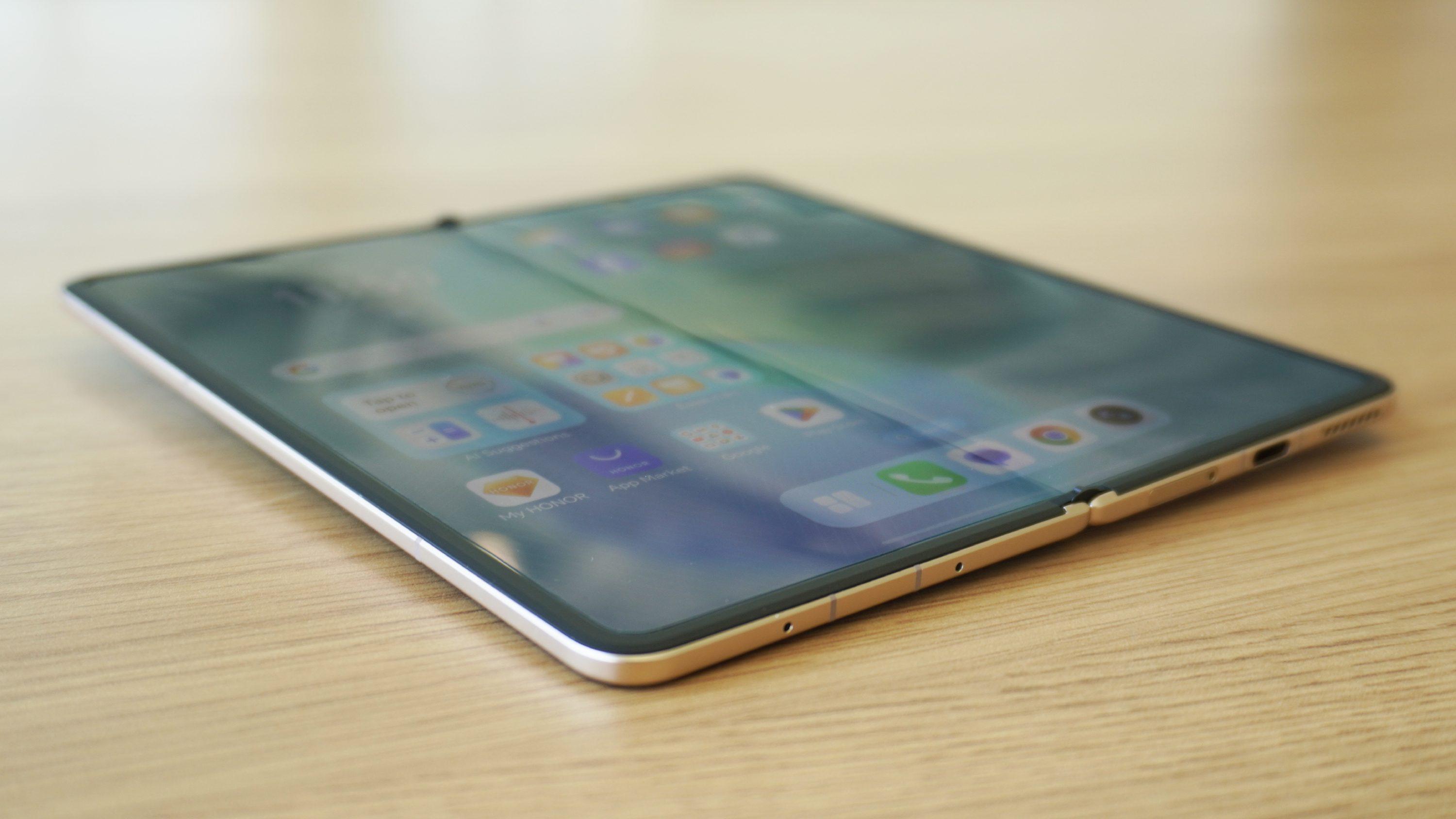 The Magic V5 unfolded with the screen on, with an angle showing the screen crease