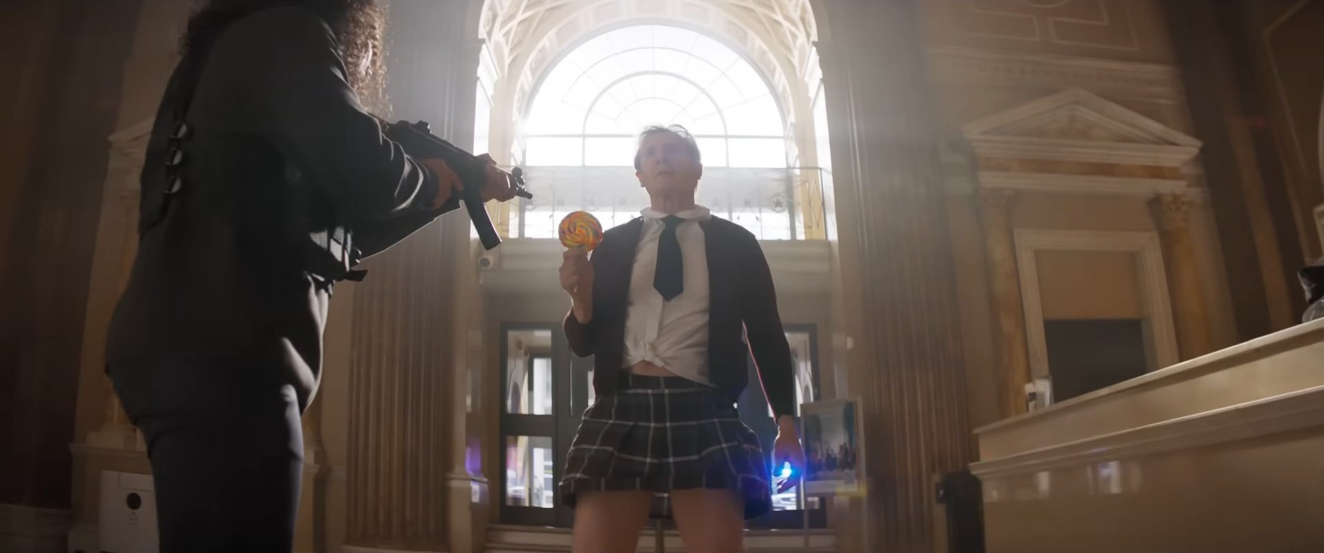 Liam Neeson at gunpoint while dressed as a schoolgirl in The Naked Gun.