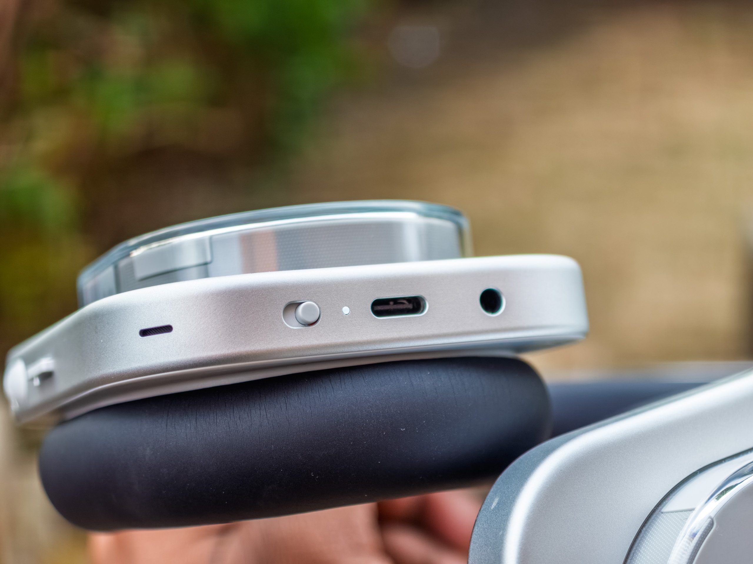 The power button, USB-C port, volume rocker and paddle on the Nothing Headphone 1 in white.