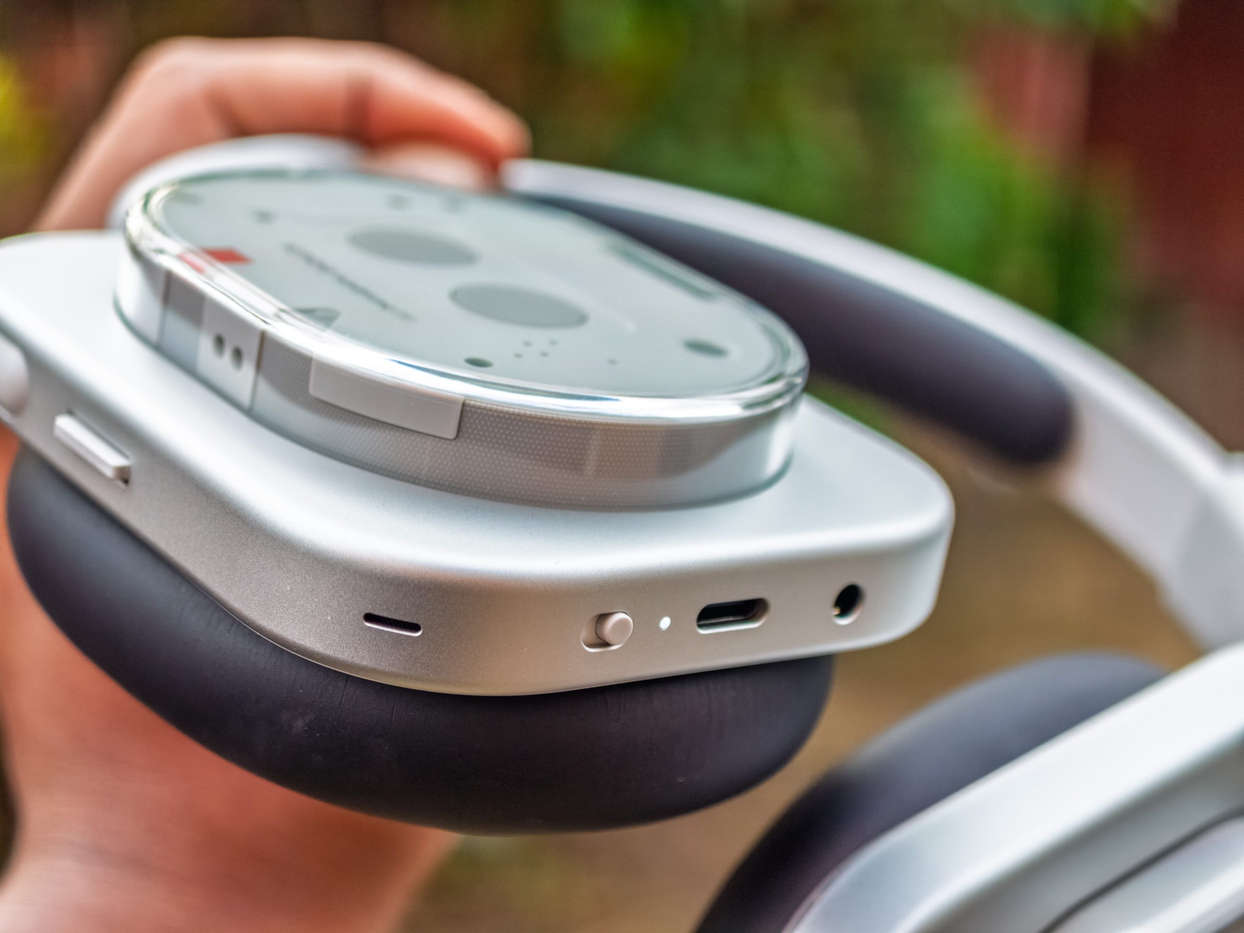 The power button, USB-C port, volume rocker and paddle on the Nothing Headphone 1 in white.