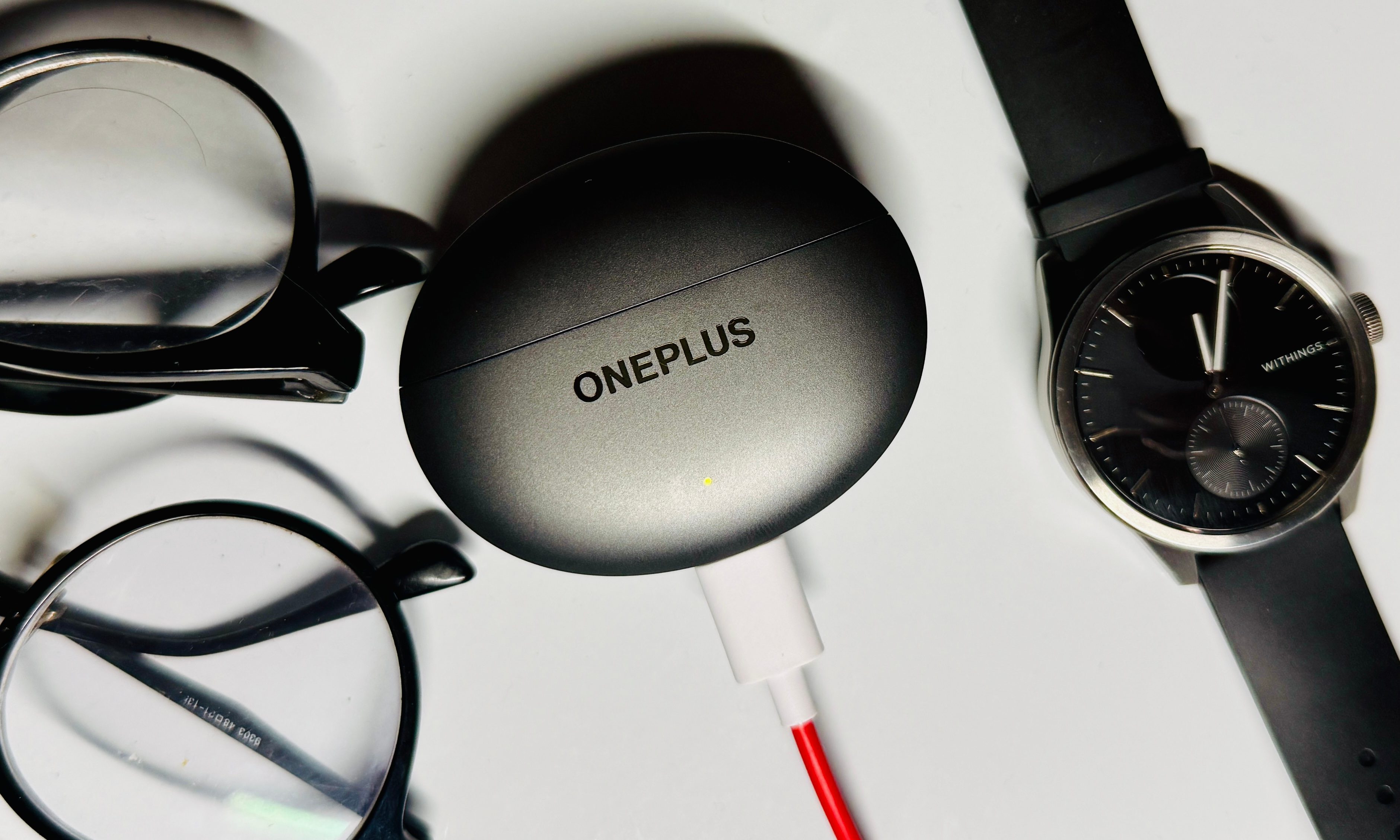 Charging the OnePlus Buds 4 earbuds.