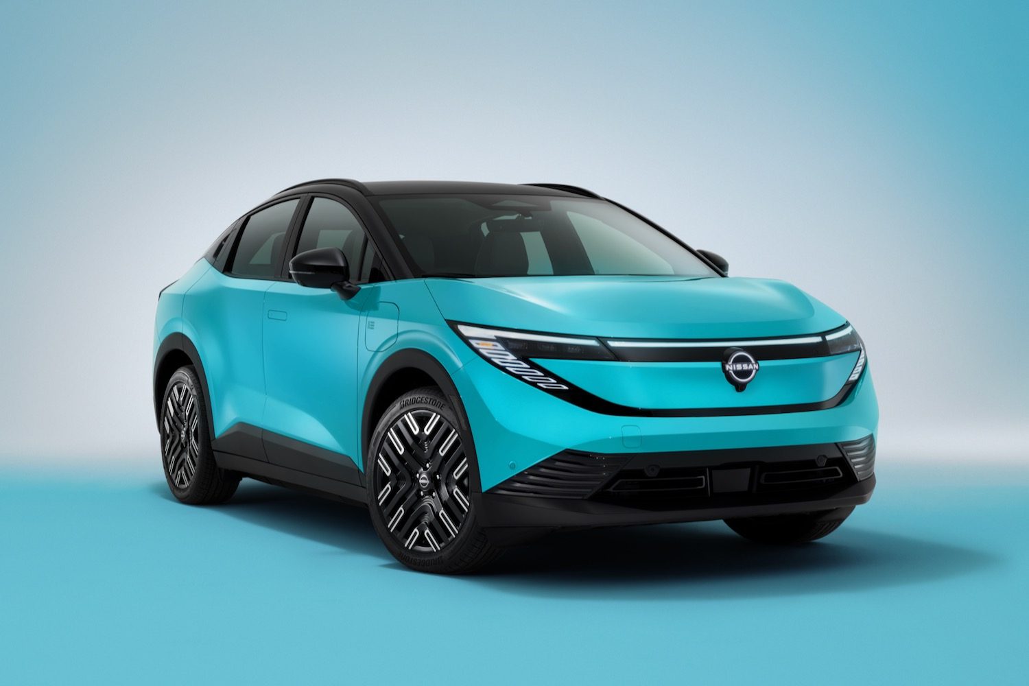 2026 Nissan Leaf front quarter view, studio background.