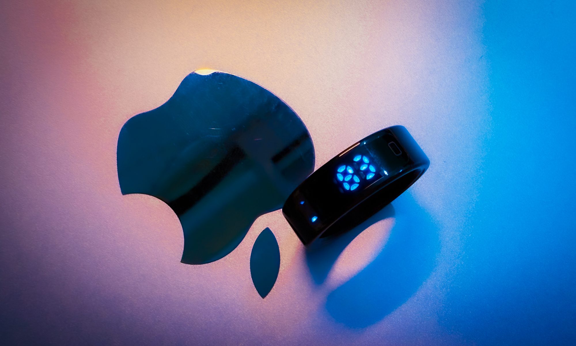 Pebble Halo smart ring against Apple logo.