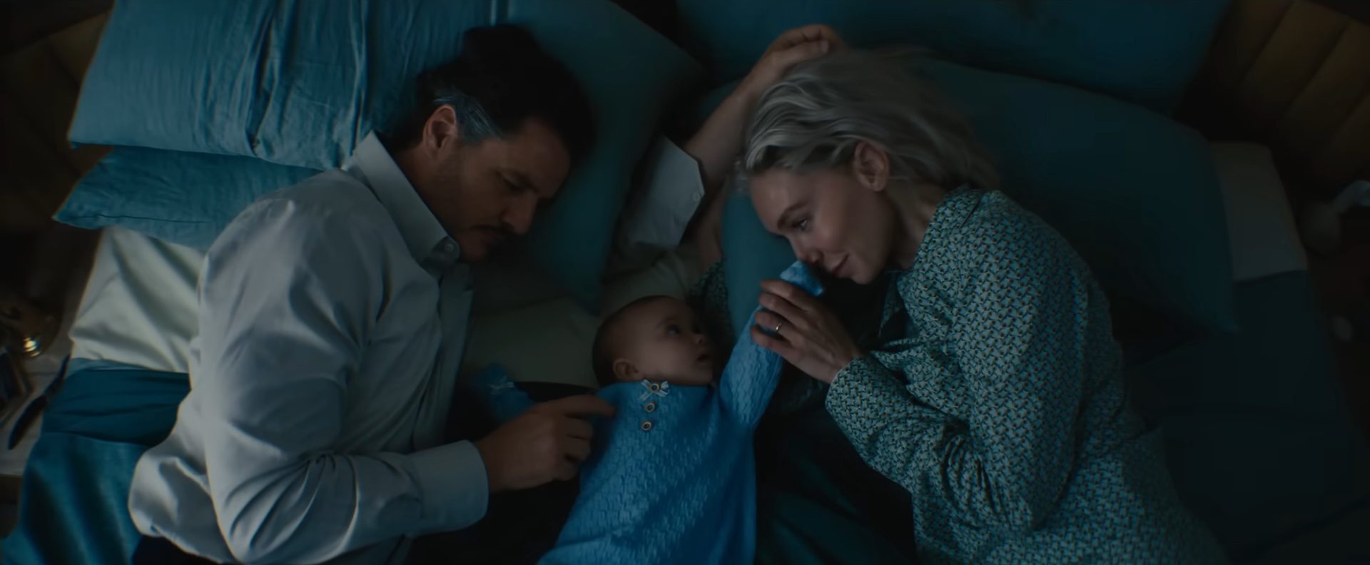 Pedro Pascal and Vanessa Kirby as Reed Richards and Sue Storm with a baby Franklin Richards in The Fantastic Four: First Steps.