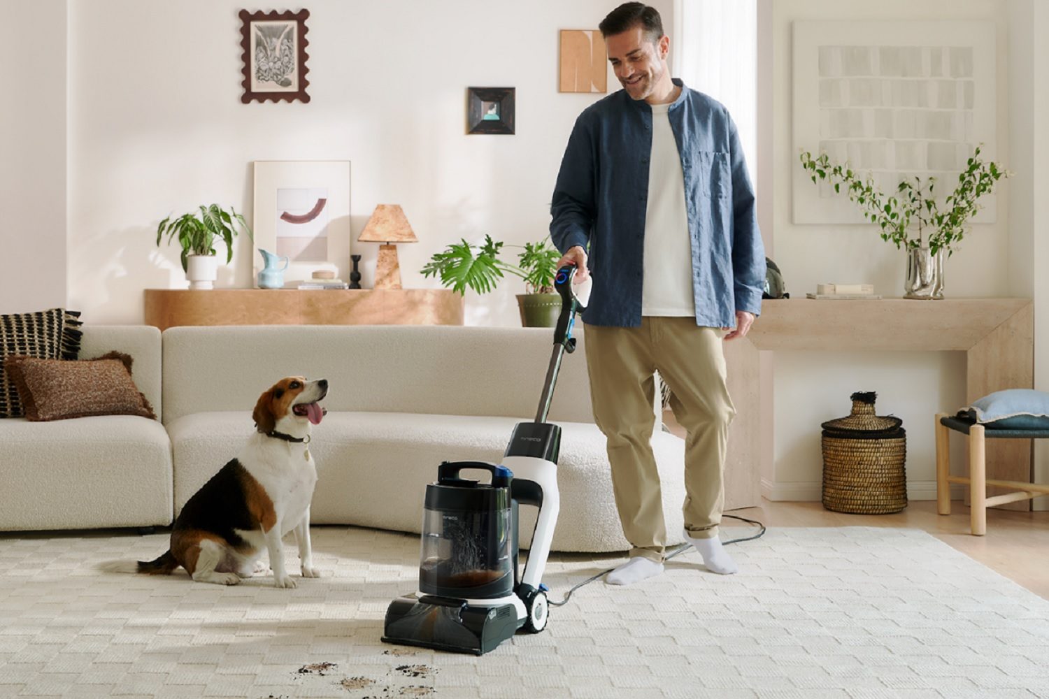 A man using the Tineco Carpet One Cruiser Smart Carpet Cleaner.