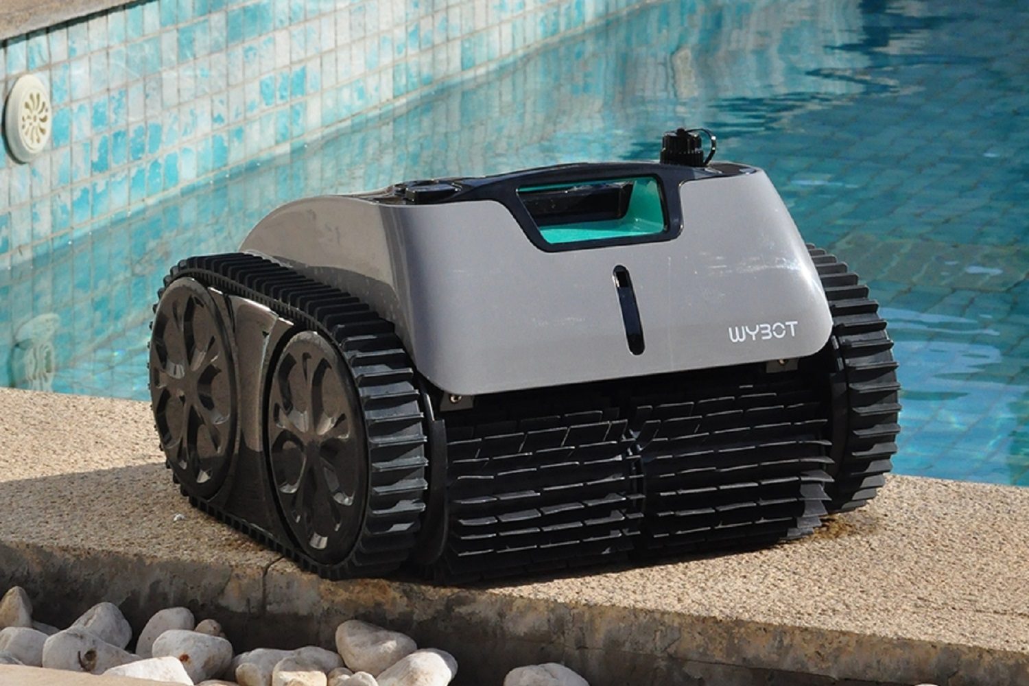 The Wybot C1 Pro robotic pool cleaner beside the swimming pool.