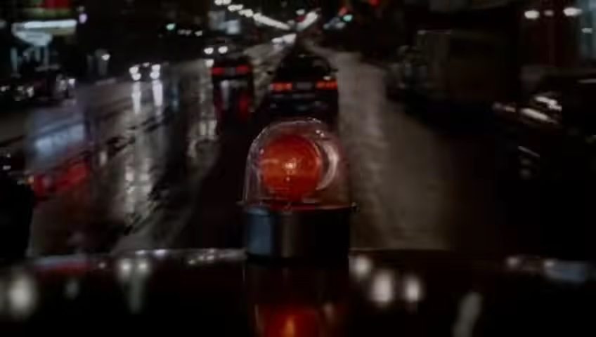 A police car driving down a road in The Naked Gun From the Files of Police Squad.