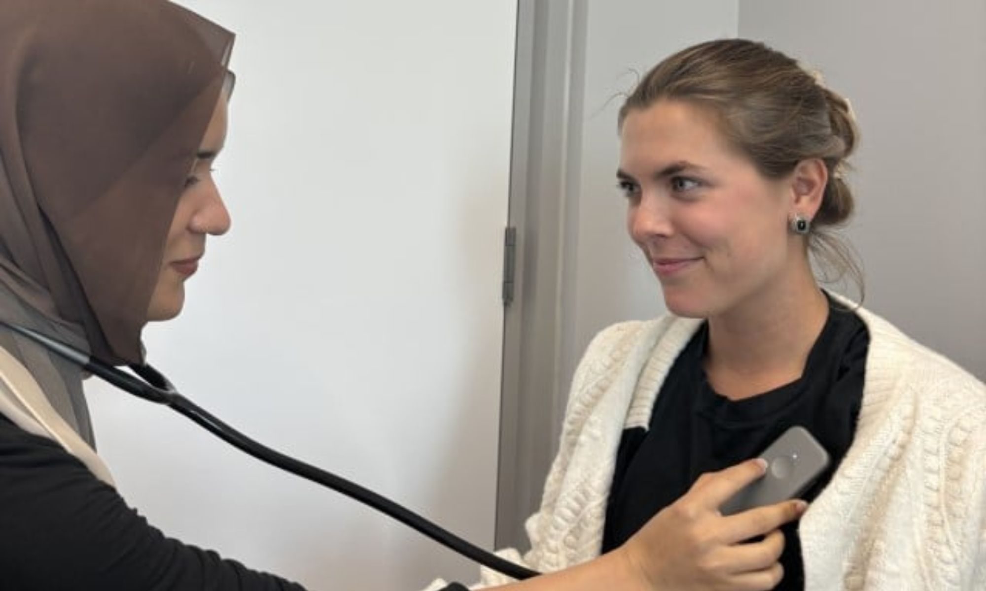 Doctor using AI stethoscope.