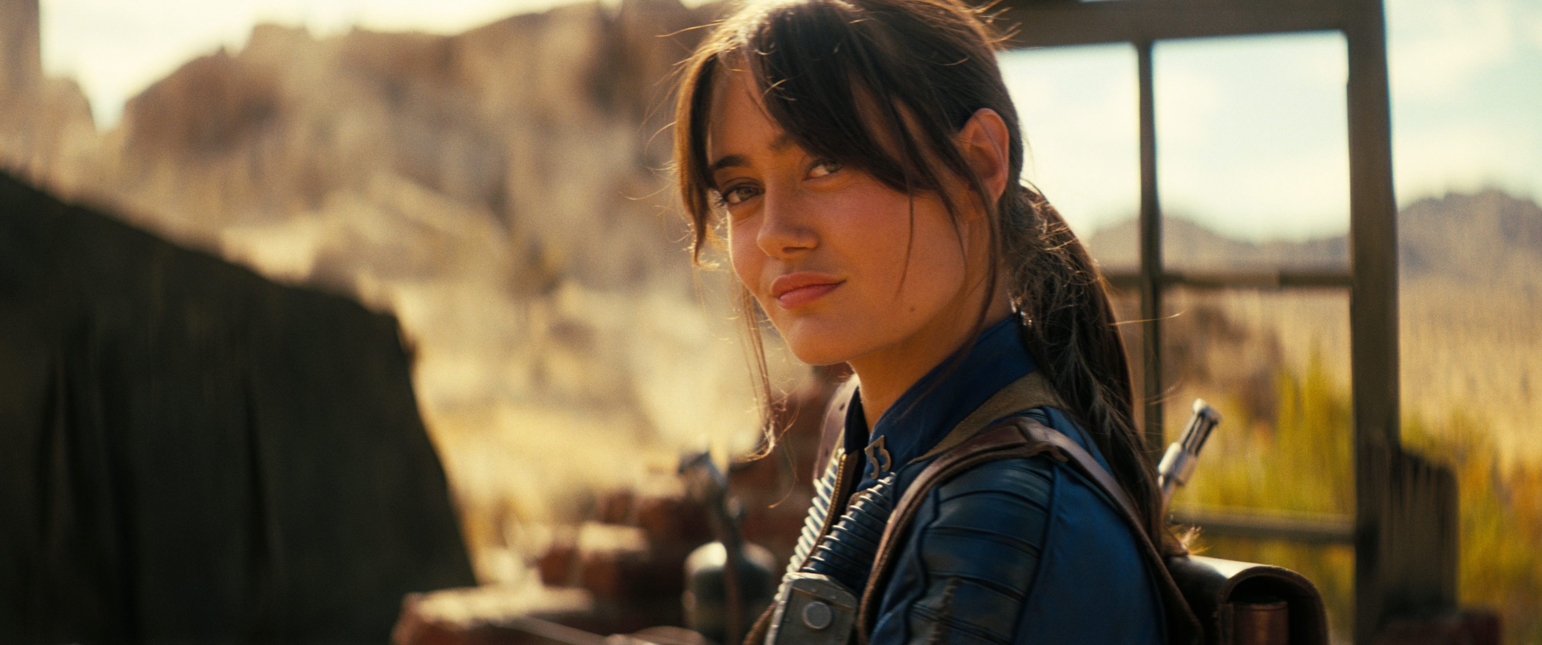 A woman looks to her left and stares.