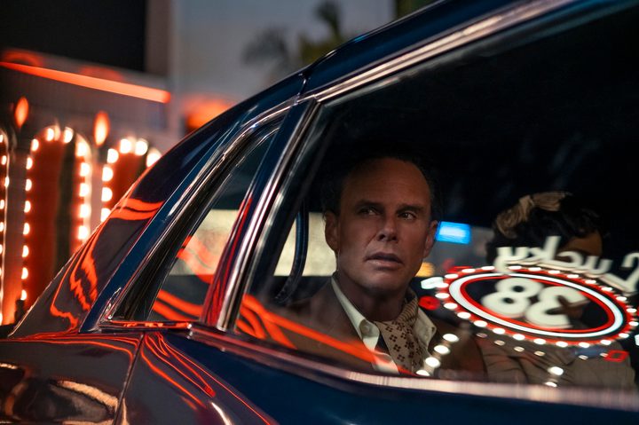 A man sits in a cab and stares.