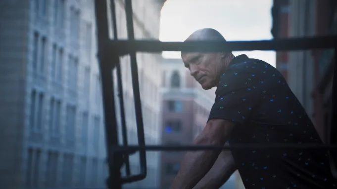 Mark Messier stands on a fire escape.