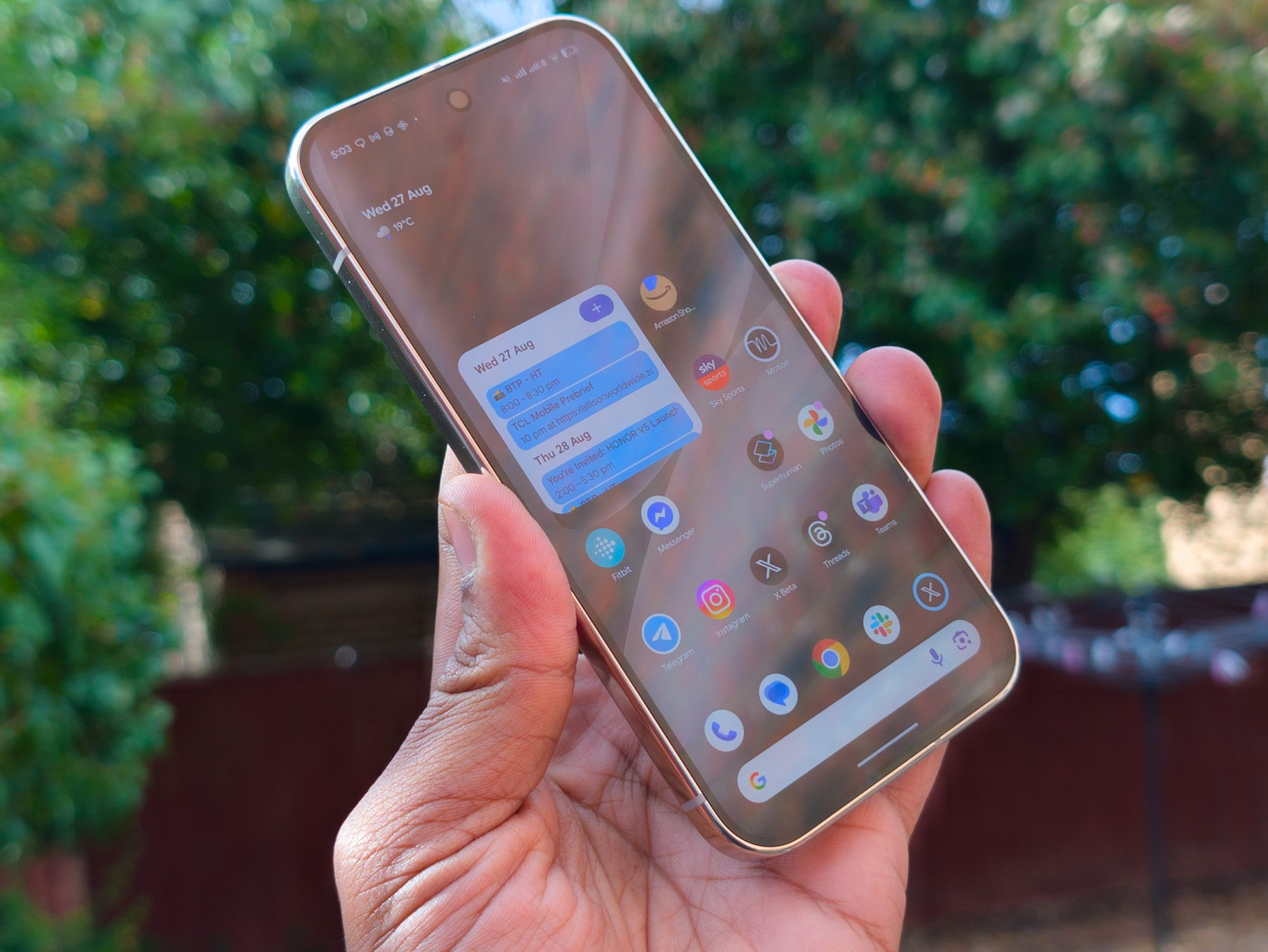 Google Pixel 10 Pro in Porcelain in the hand with the display on