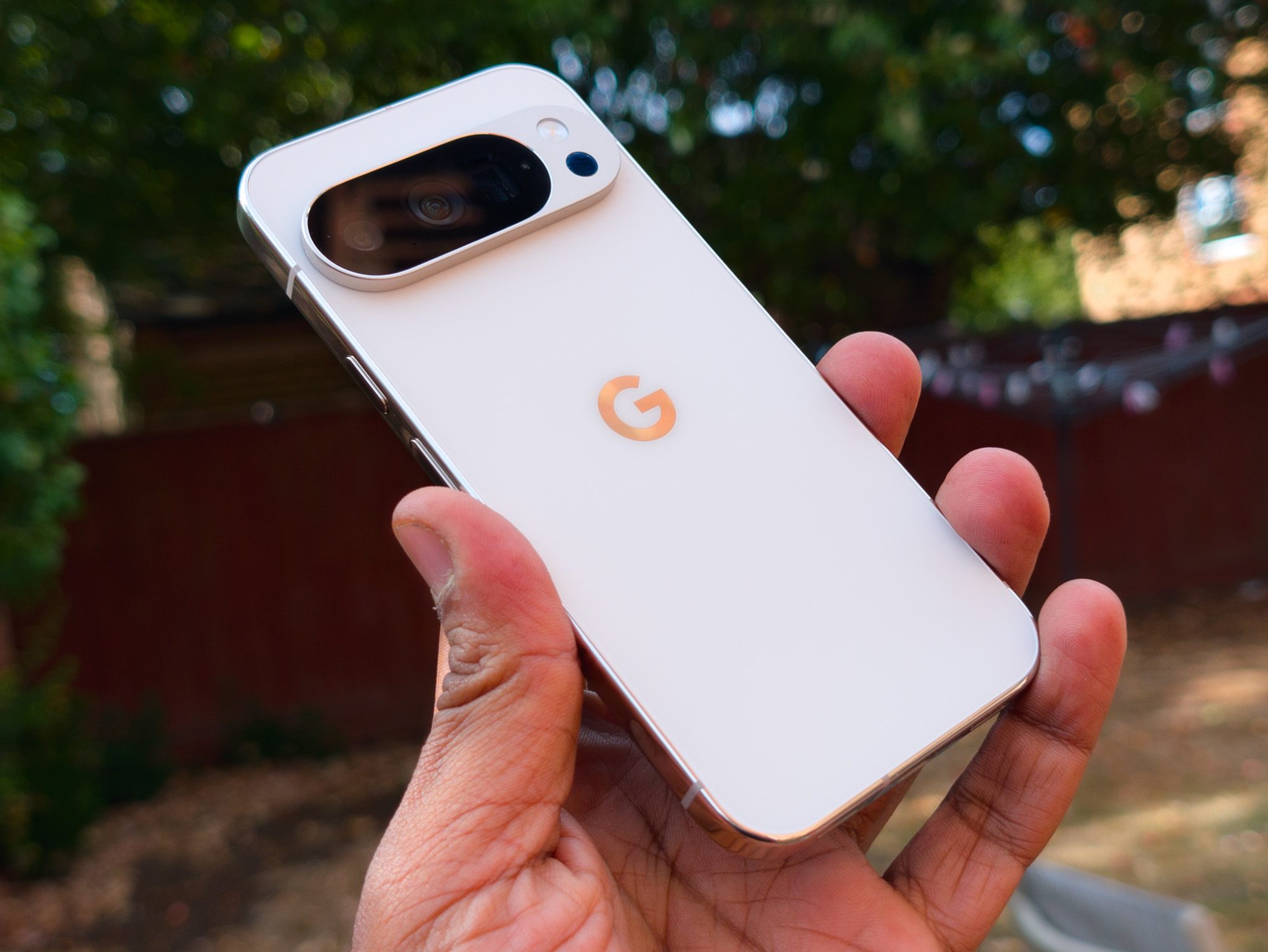 Angled view of the back of the Google Pixel 10 Pro in Porcelain in the hand