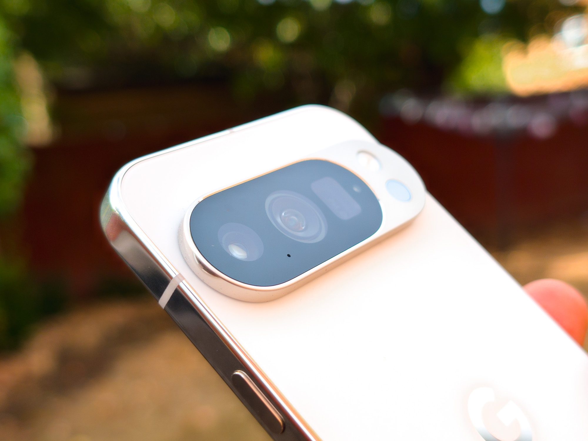 Angled view of the cameras on the Google Pixel 10 Pro in Porcelain in the hand