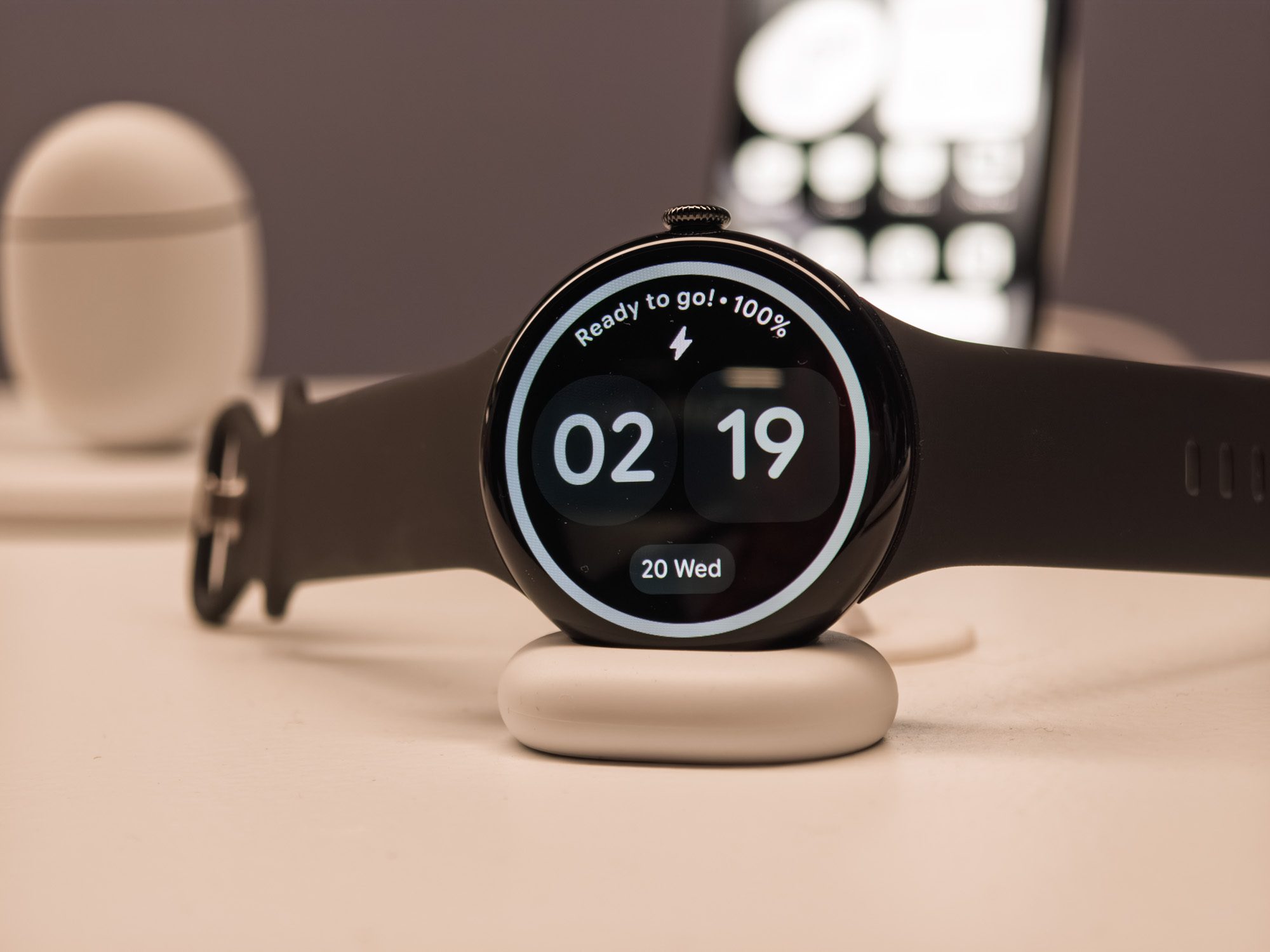 Google Pixel Watch 4 in black on a charger
