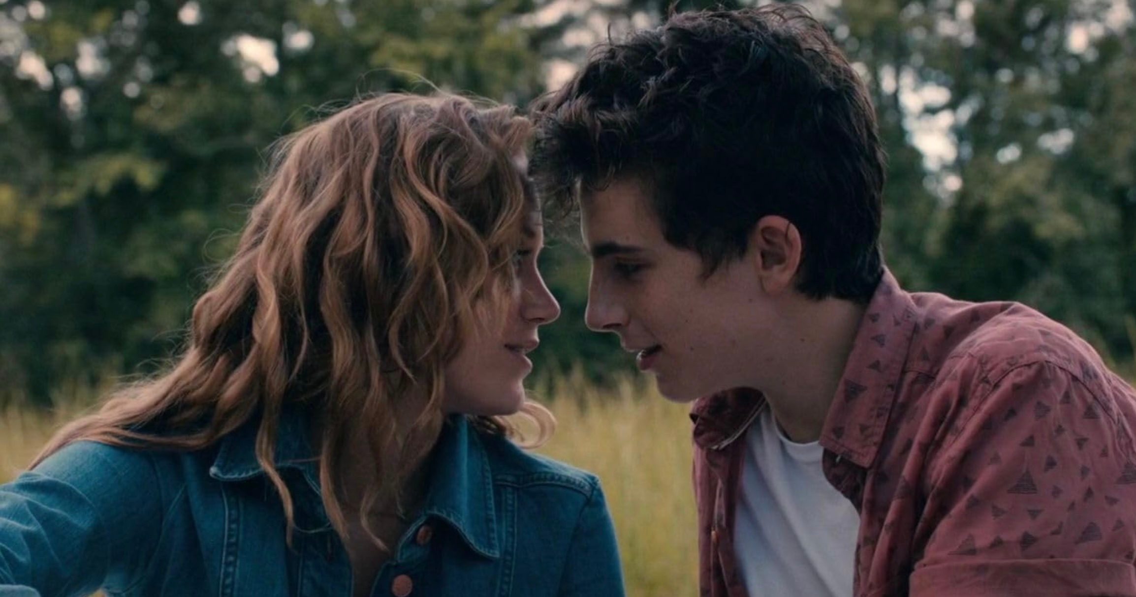 A girl and guy inch closer to kiss.