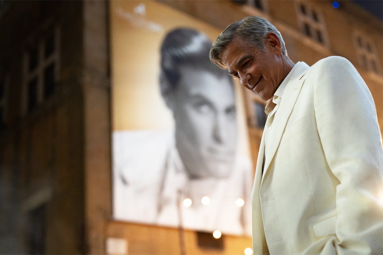 George Clooney looks down.