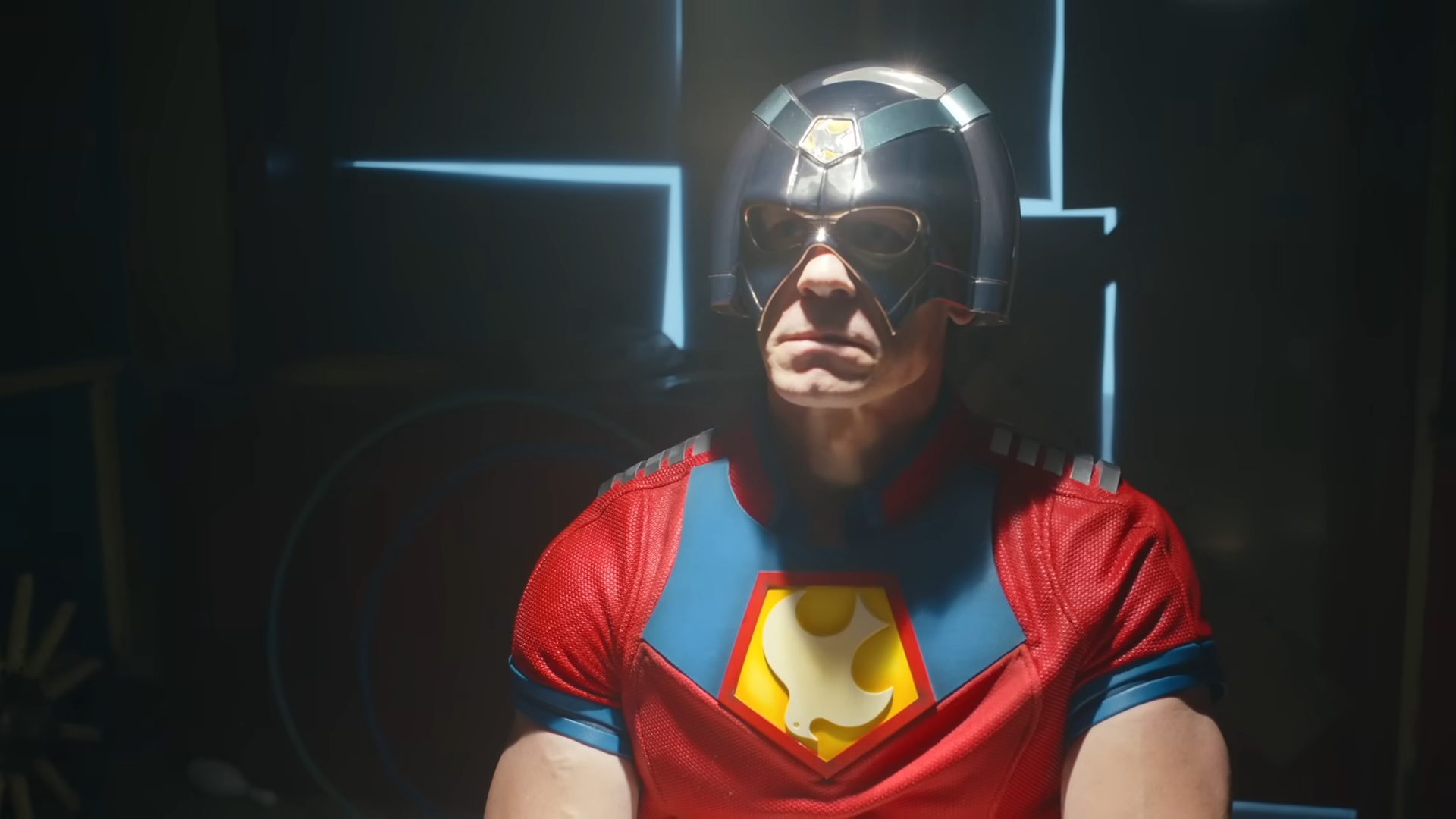 John Cena sitting as Chris Smith in Peacemaker.