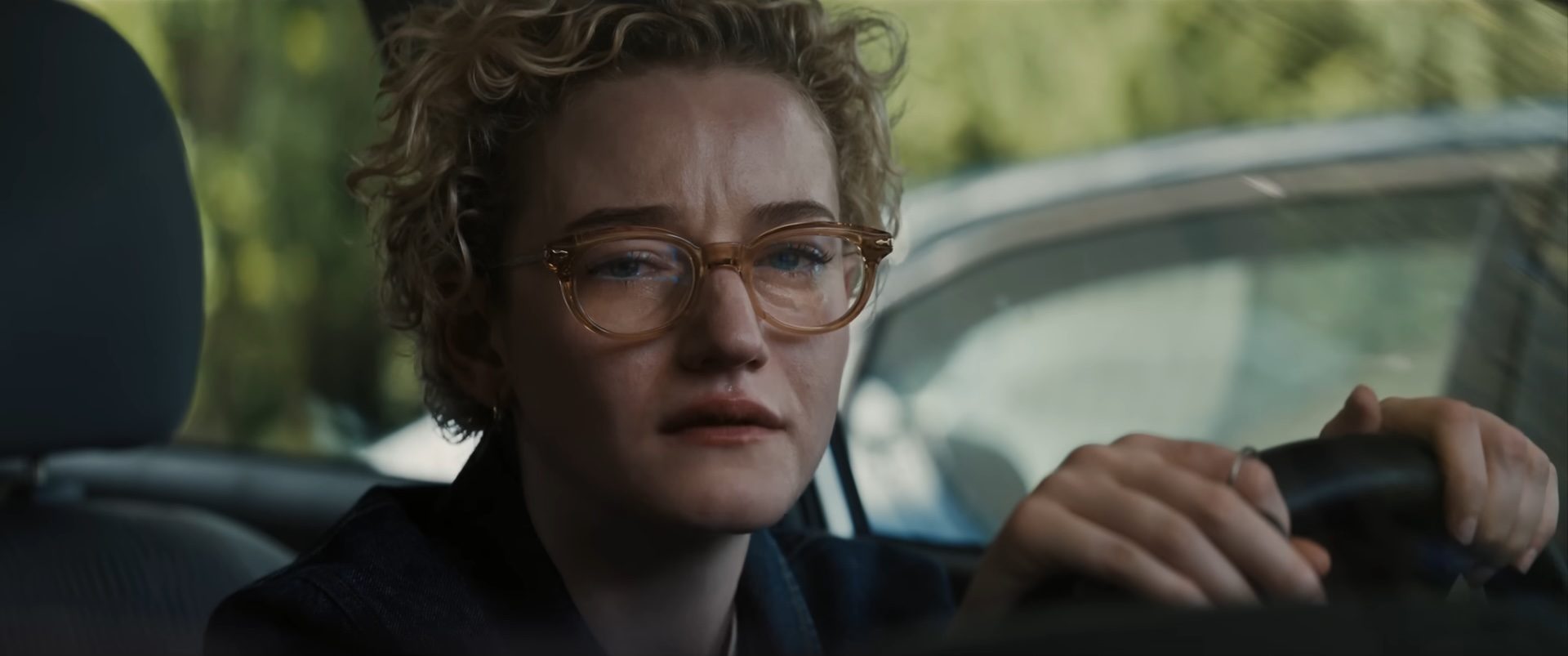 Julia Garner crying in a car in the horror film Weapons.