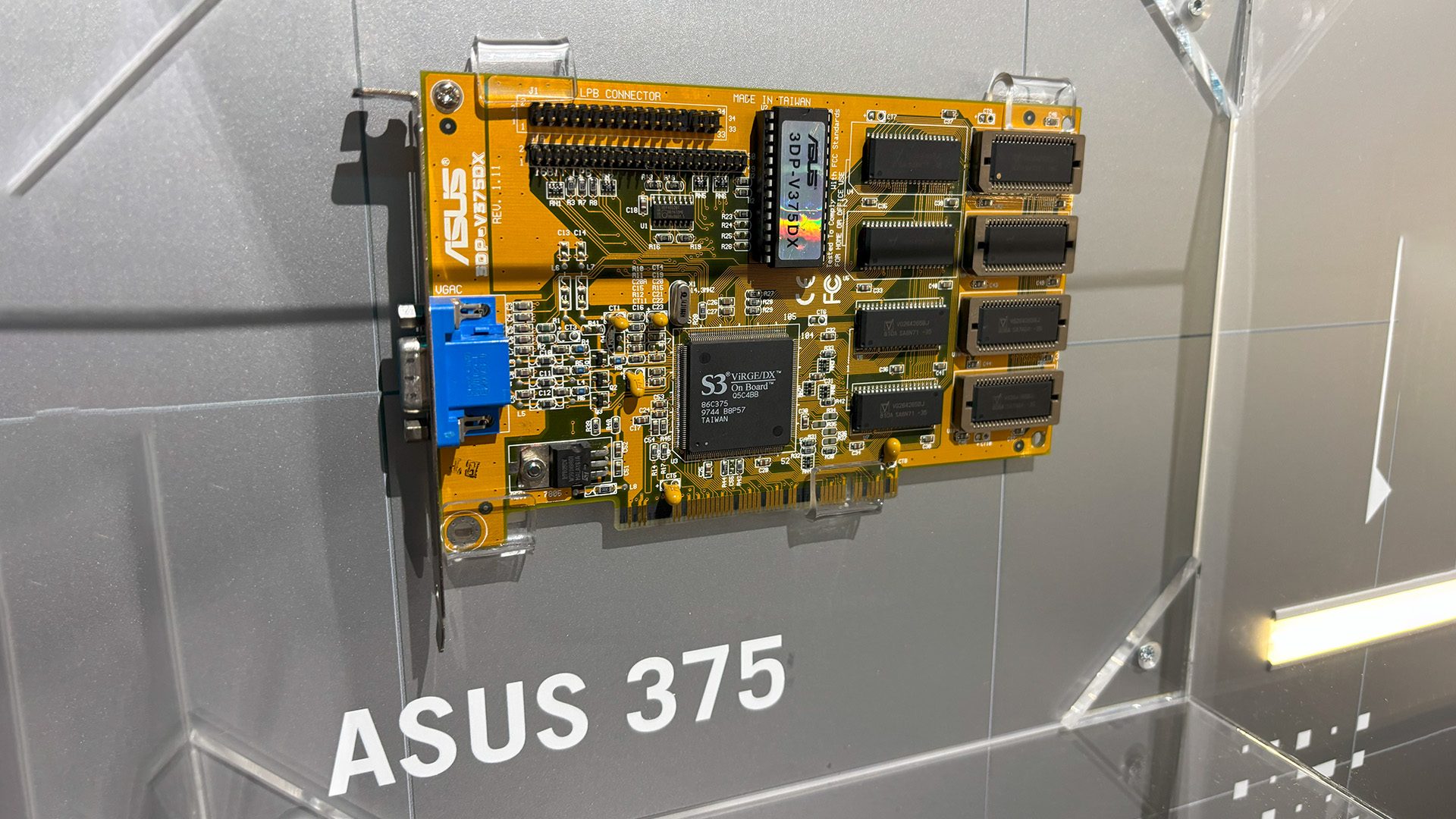 Asus 375 mounted on the wall with the name stated below. 