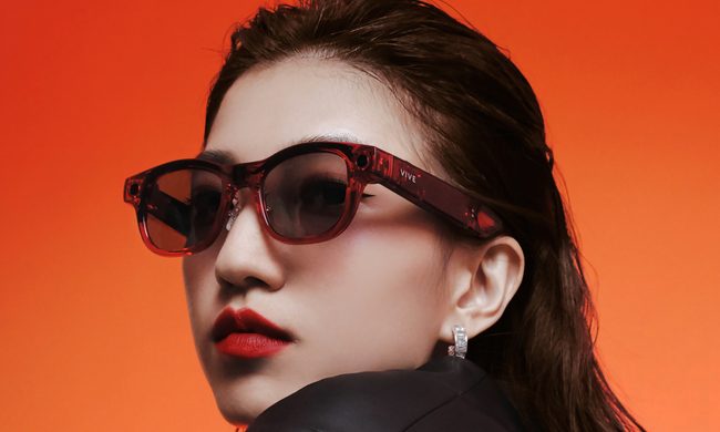 A woman wearing the HTC Vive Eagle smart glasses