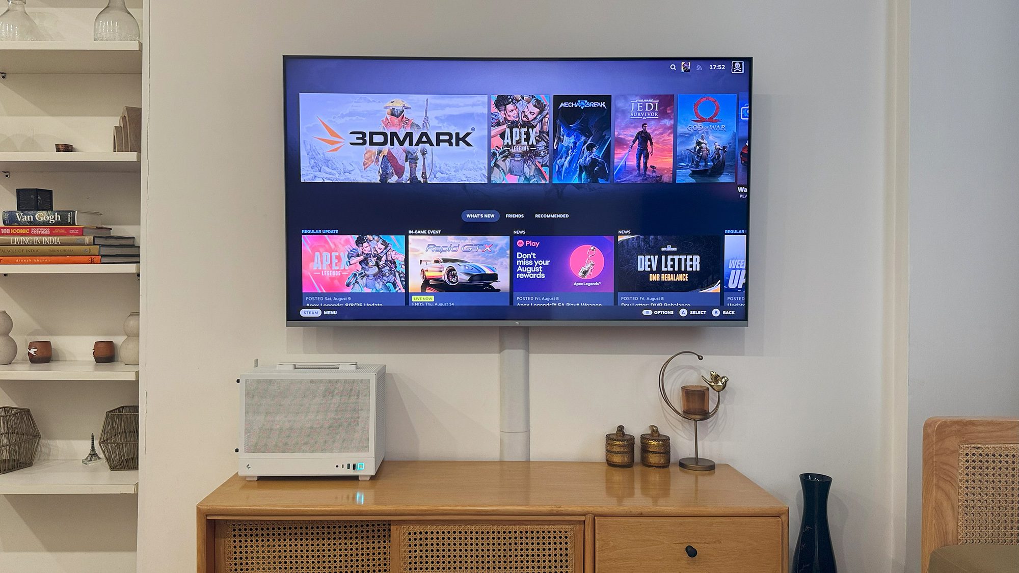 A small form factor gaming PC placed under a TV for console gaming
