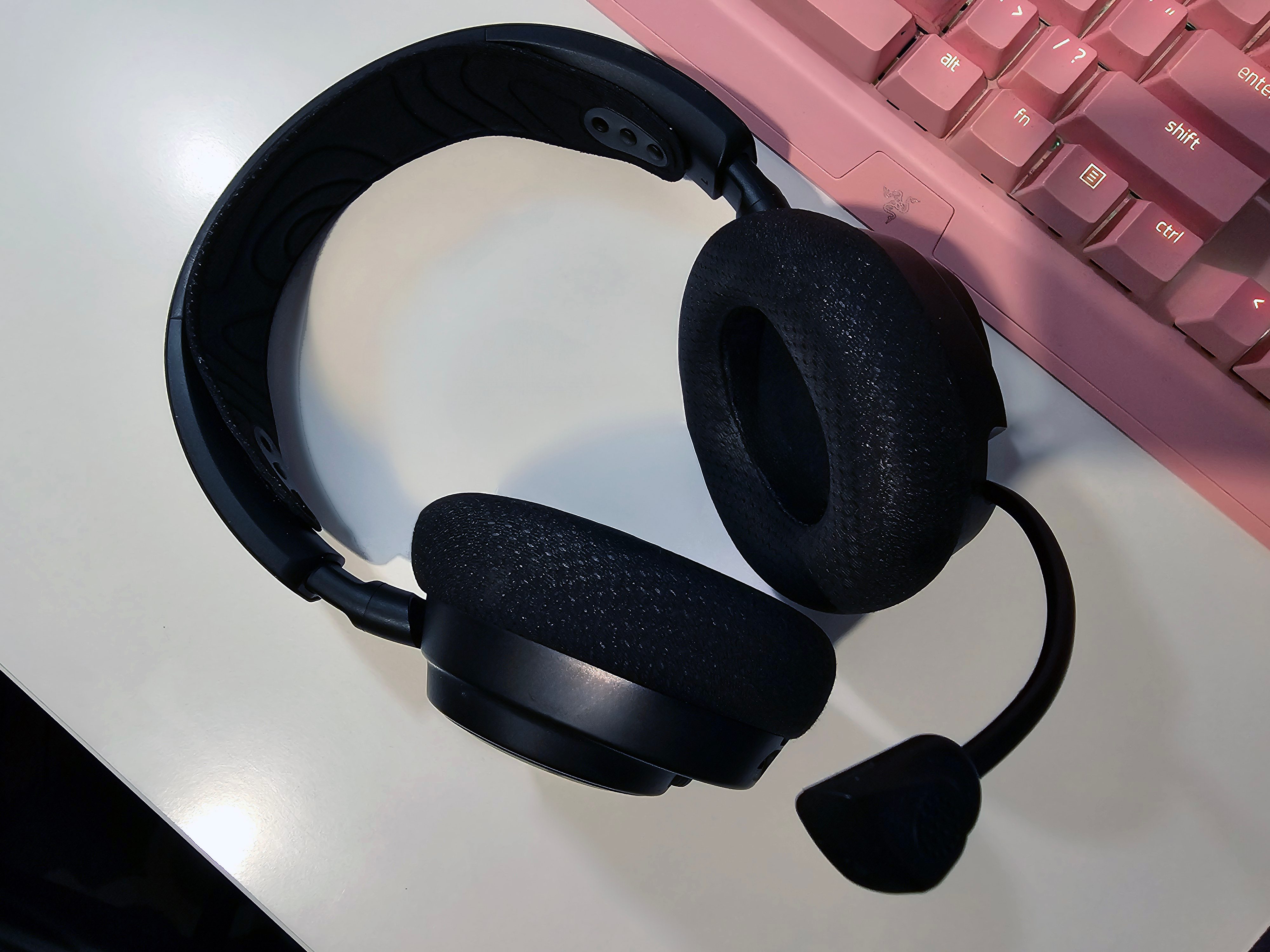 The SteelSeries Arctis Nova 7 headset on a desk.