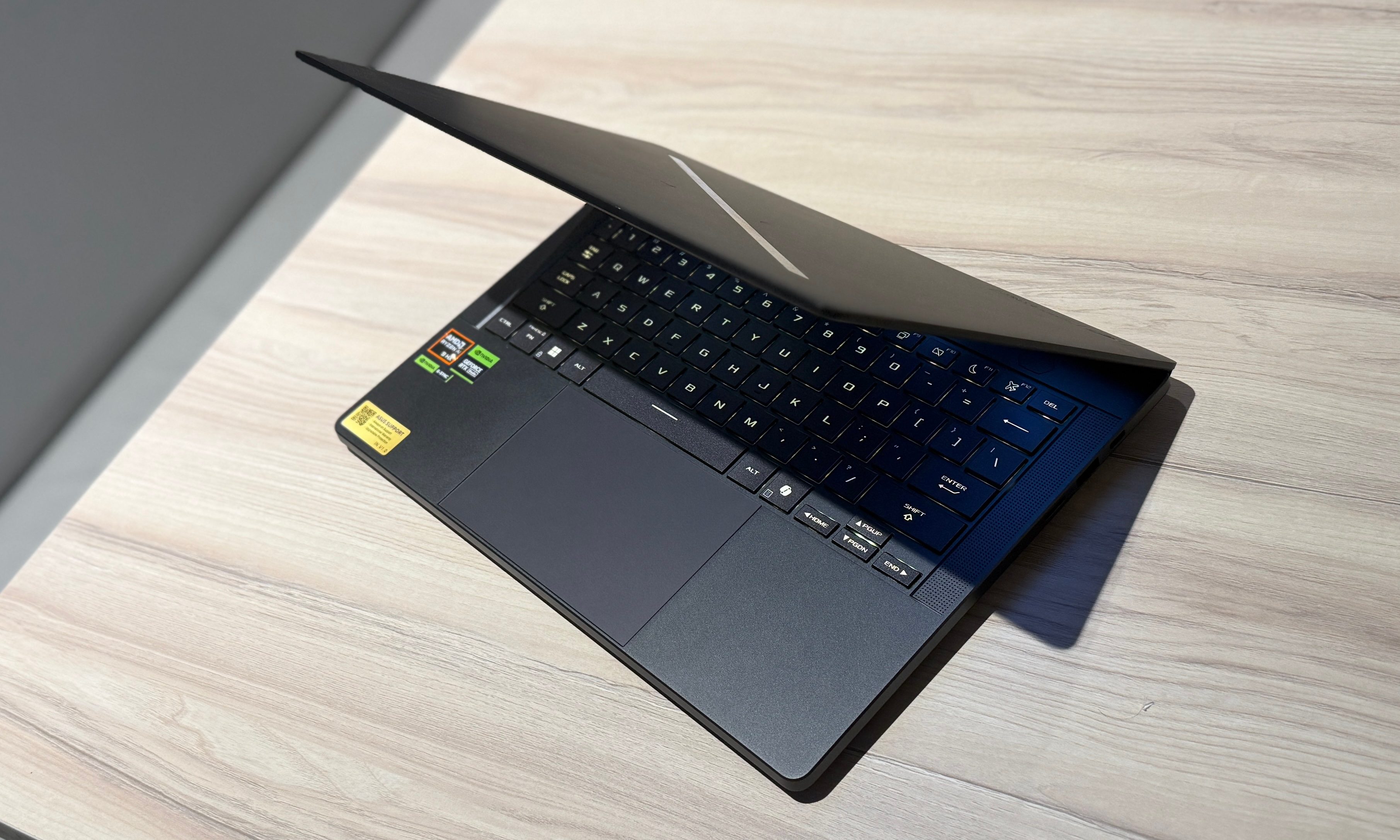 The table holds an Asus ROG Zephyrus G14 laptop