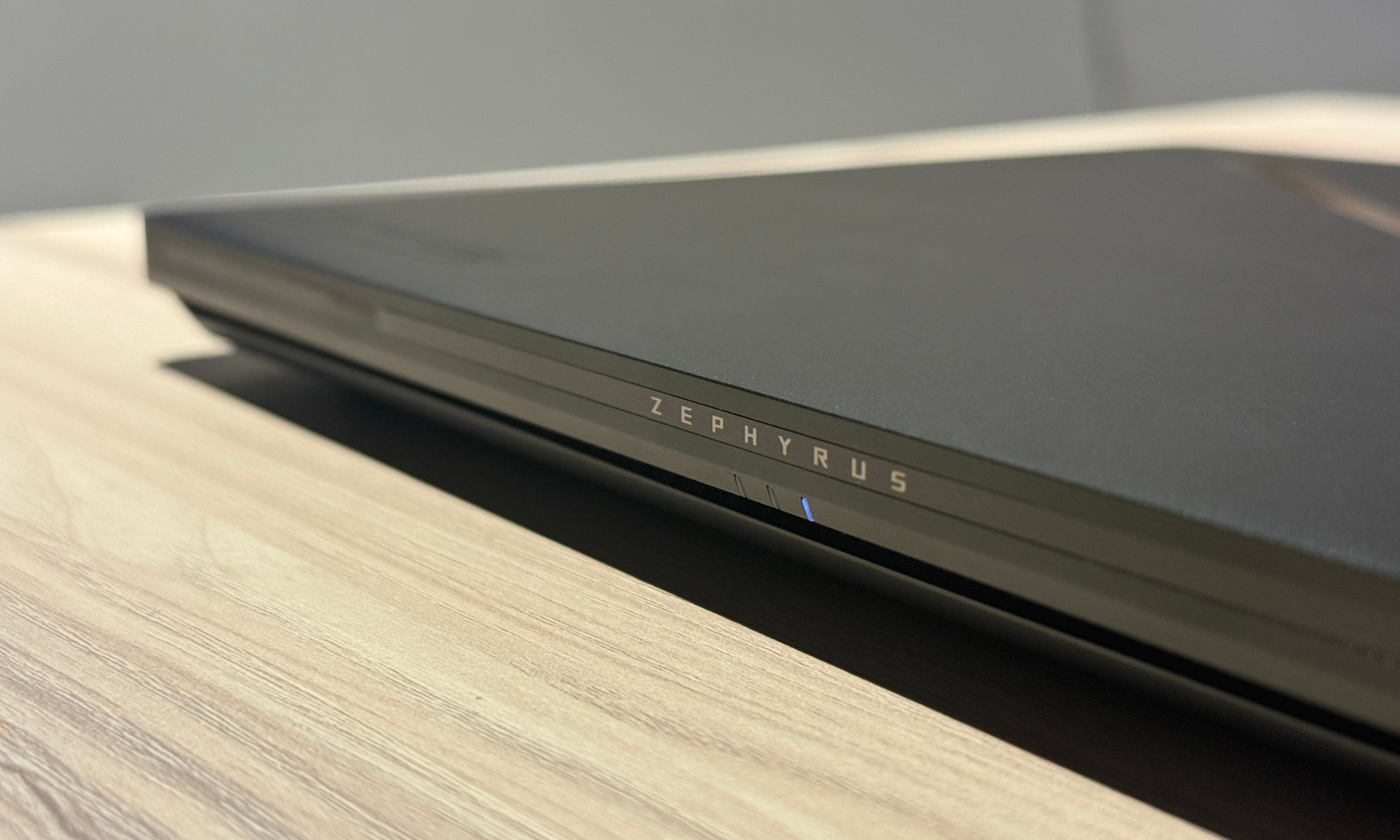 The Asus ROG Zephyrus G14 is positioned on a table.
