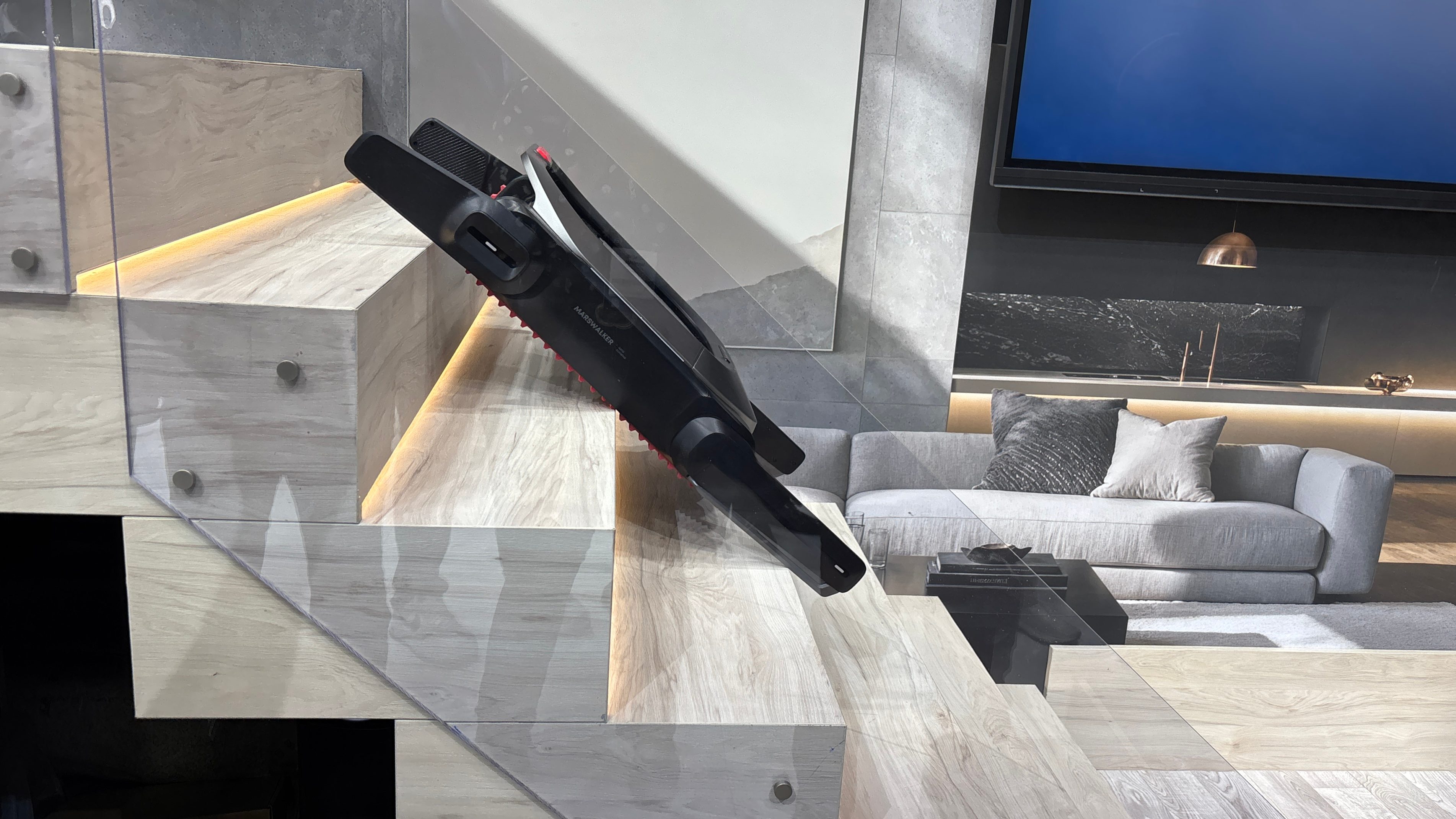 Eufy MarsWalker going up stairs with a robot vacuum inside at IFA 2025.