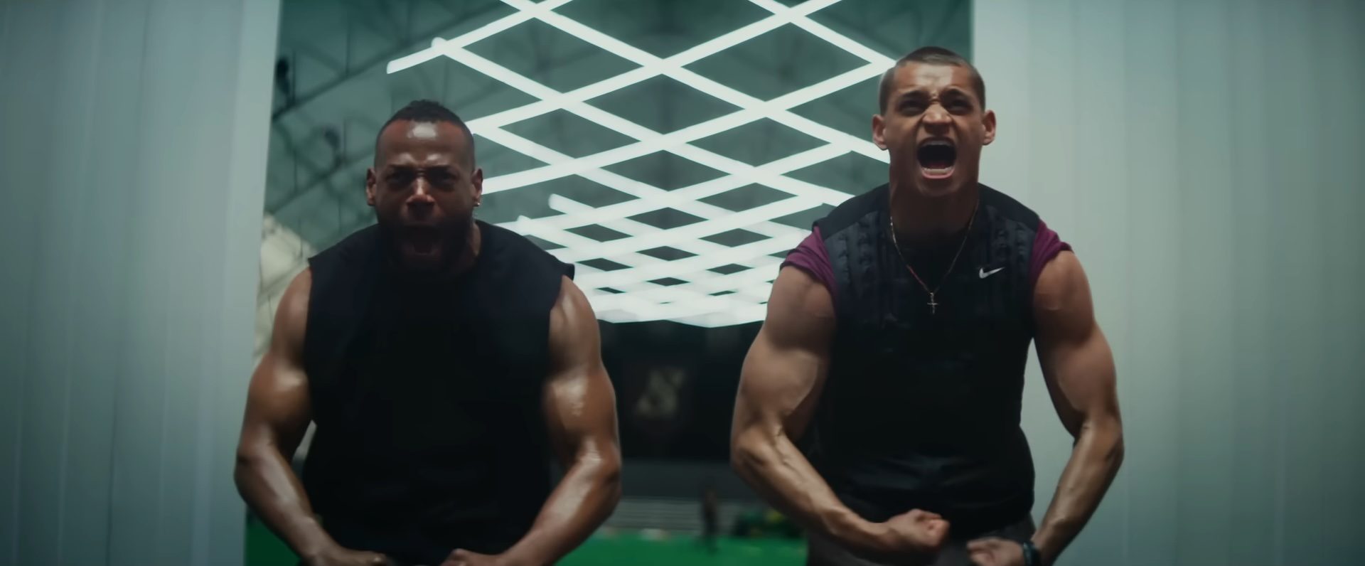 Marlon Wayans and Tyriq Withers screaming and flexing their muscles in the film, Him.