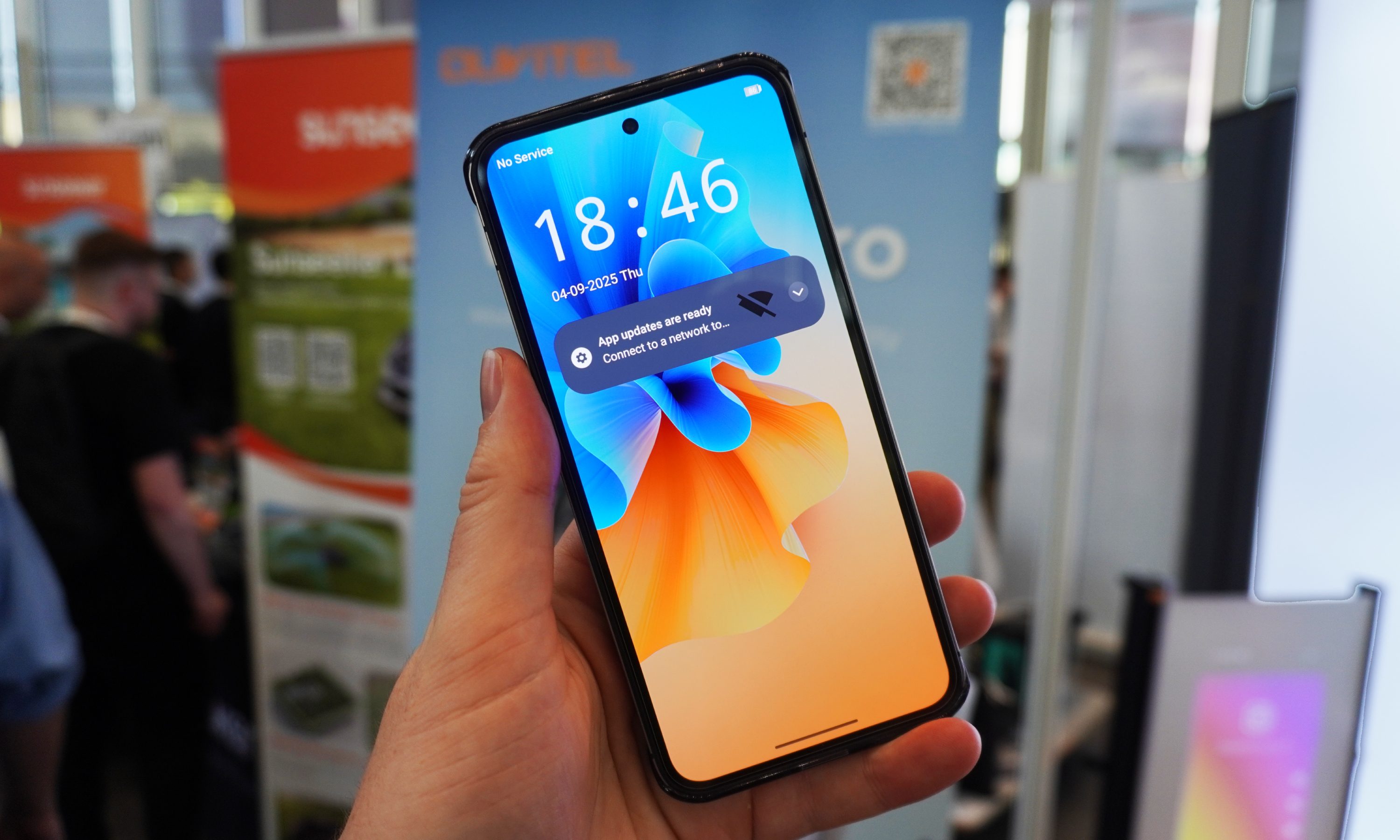 A hand holding the Oukitel WP200 with the screen on