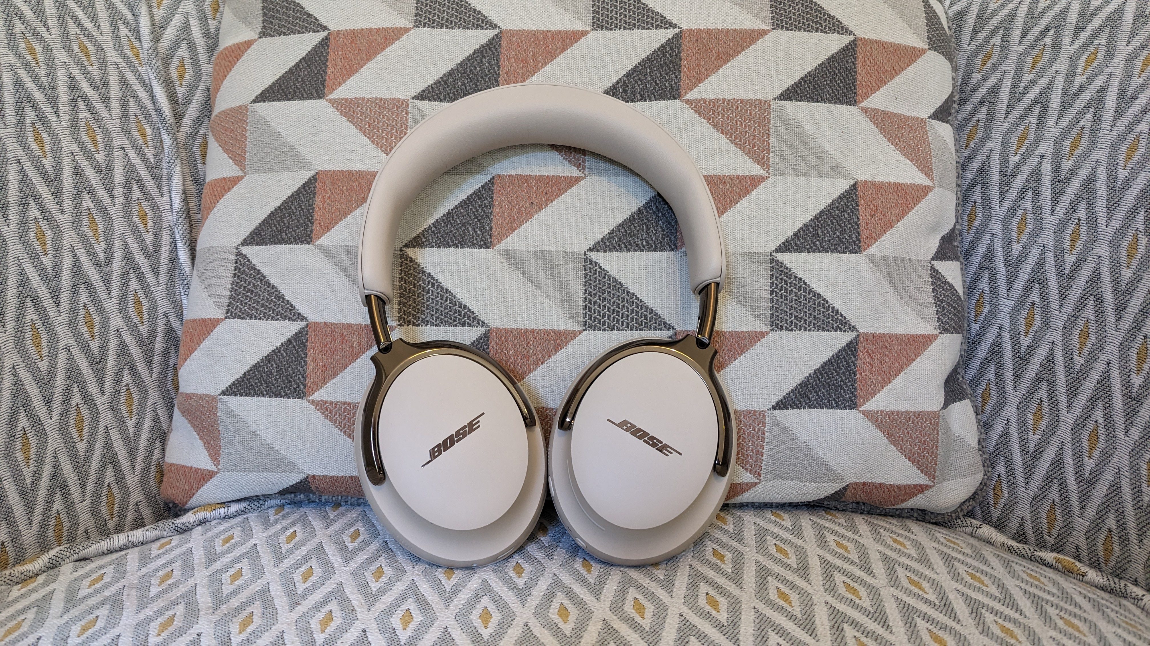 Bose QuietComfort Ultra Headphones (2nd Gen) in front of a patterned cushion