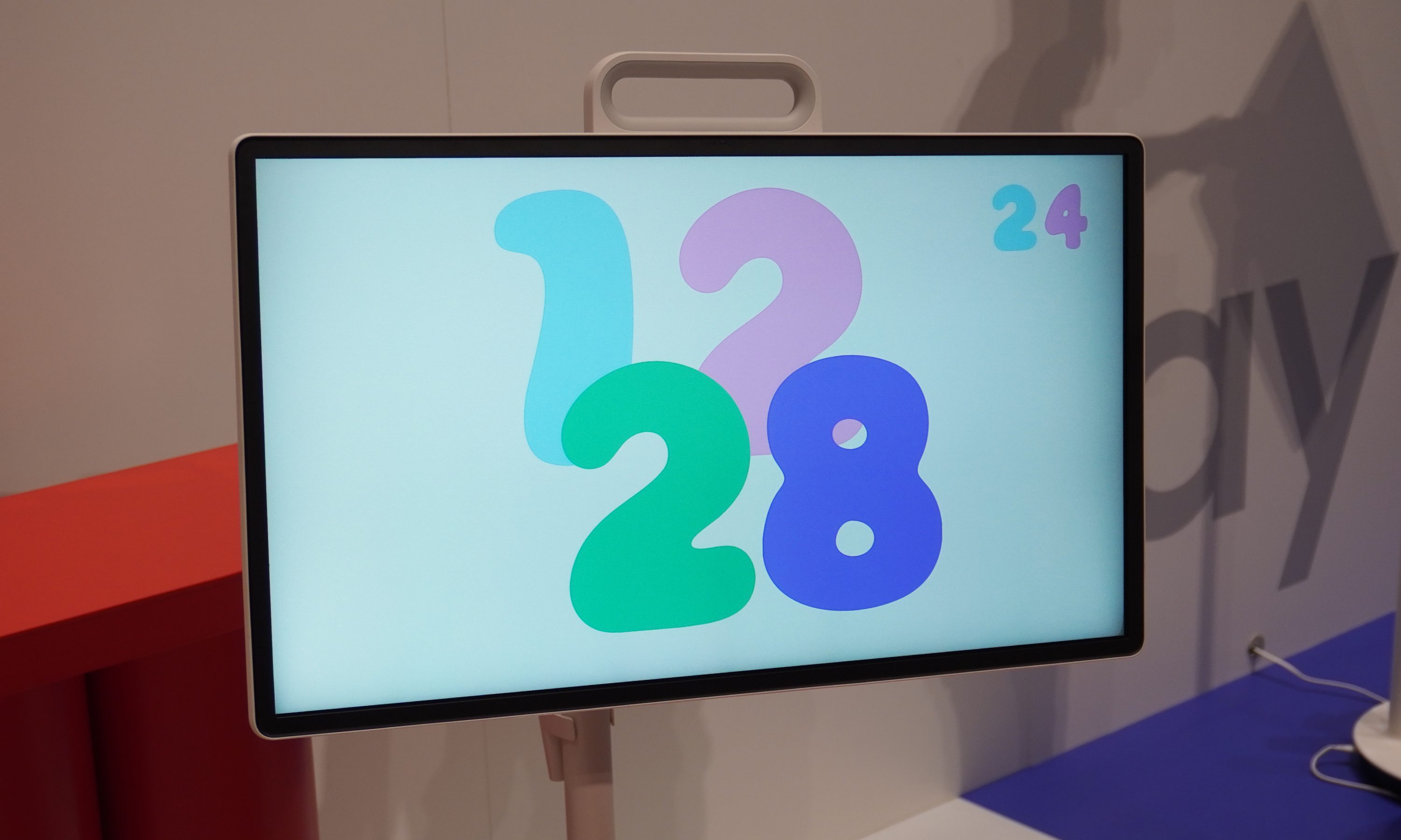 A 26-inch TV with a carry handle peeking out the top edge