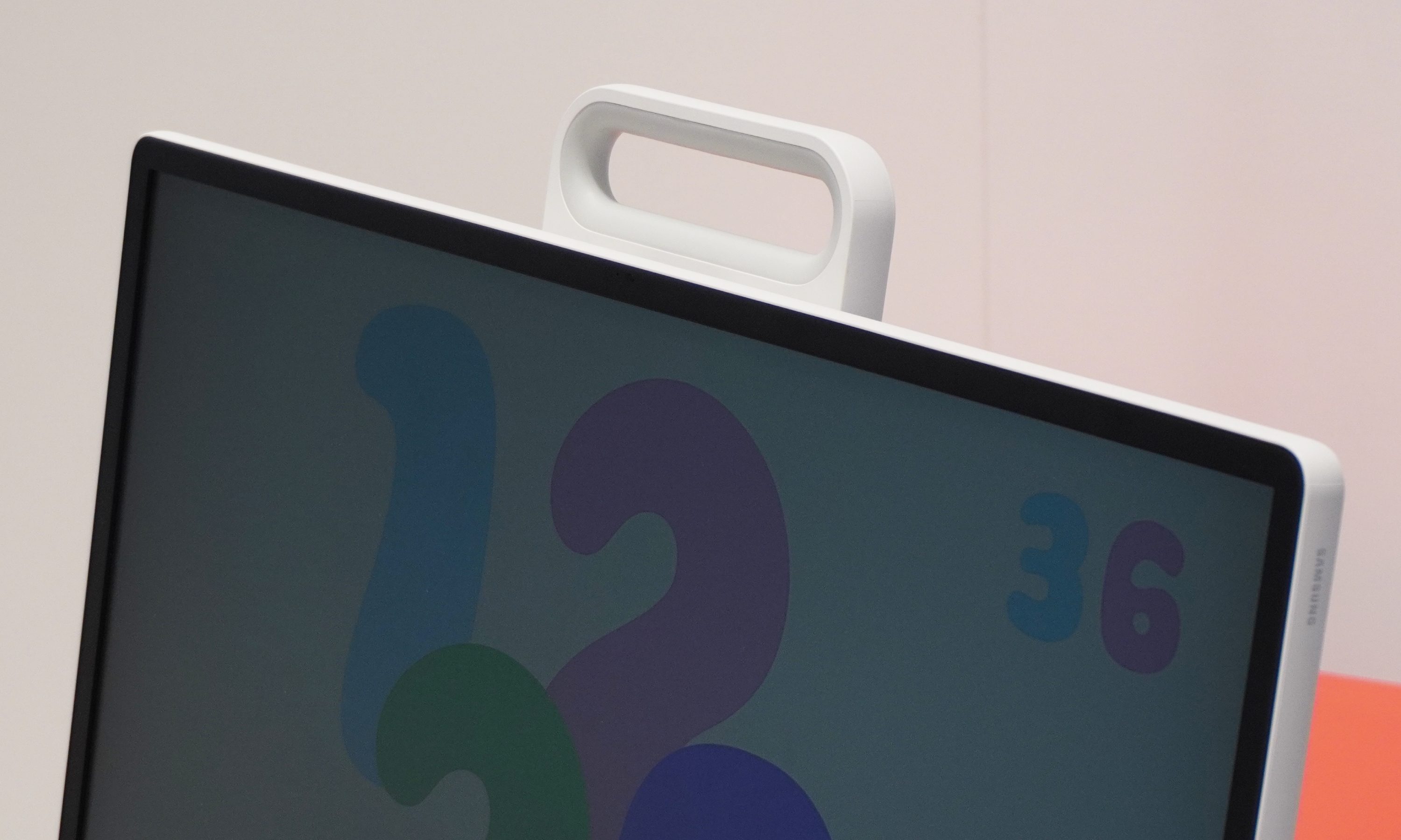A built-in carry handle appearing above a TV display