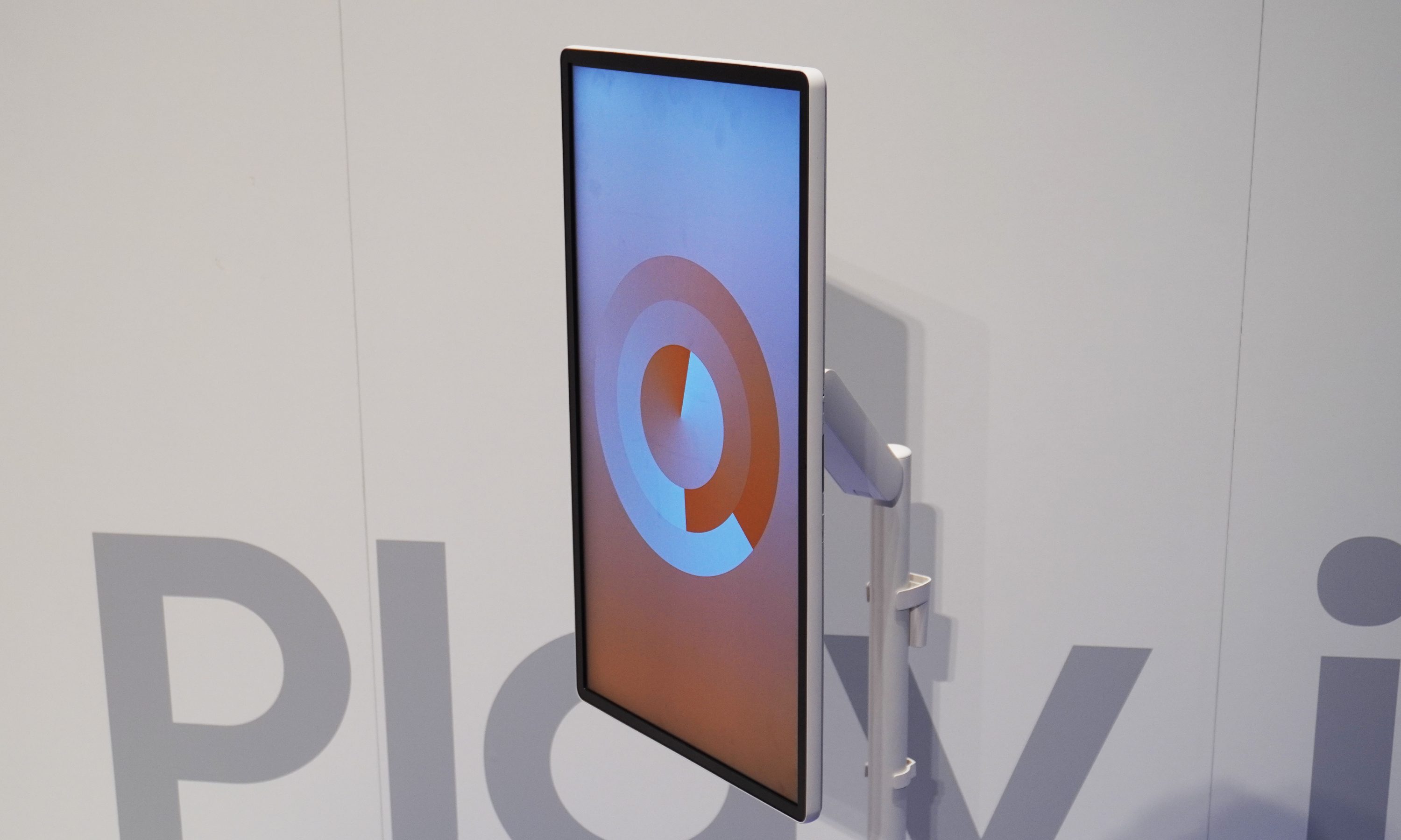 A TV in portrait orientation on a stand.