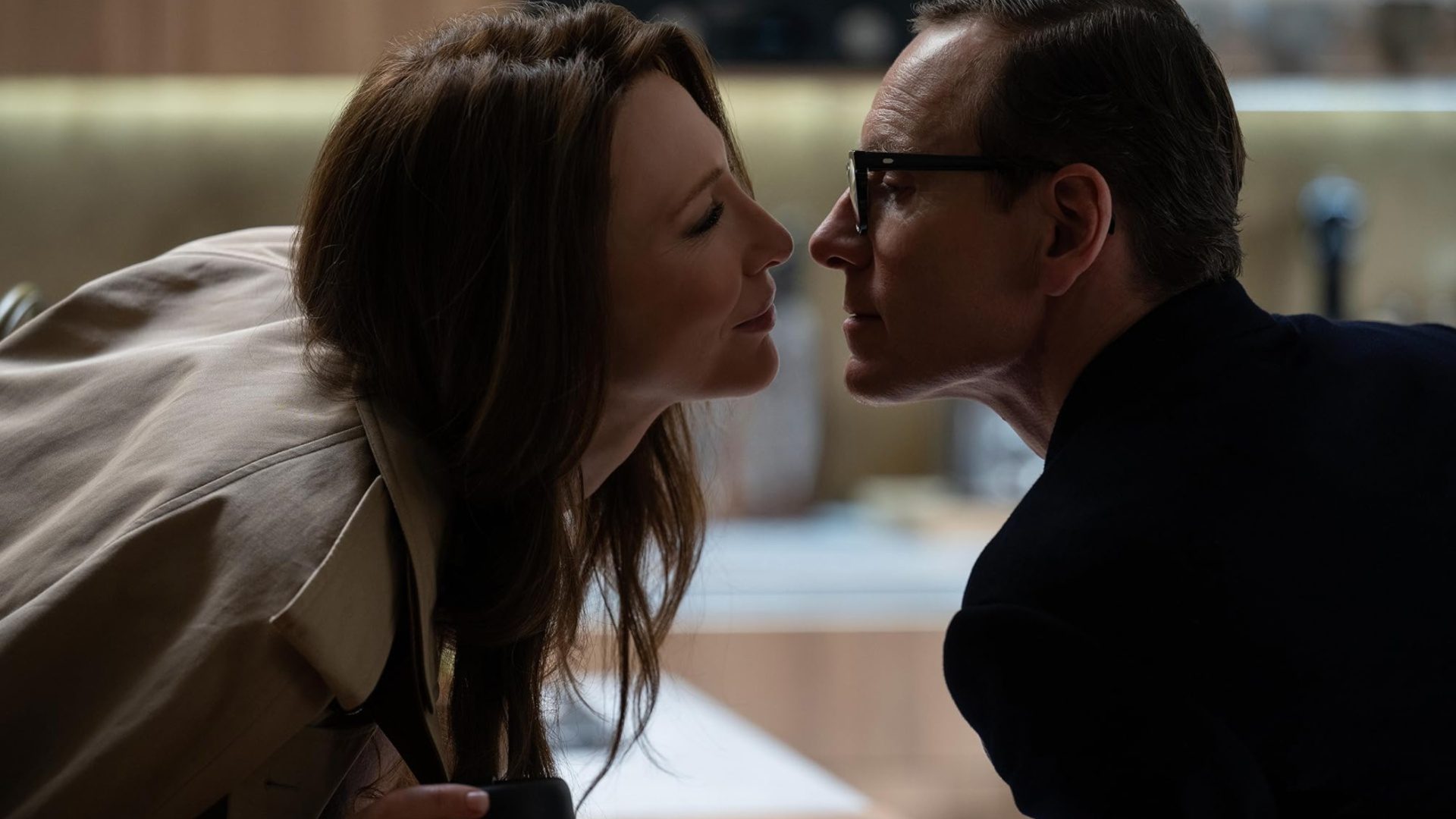 A husband and wife go to kiss.