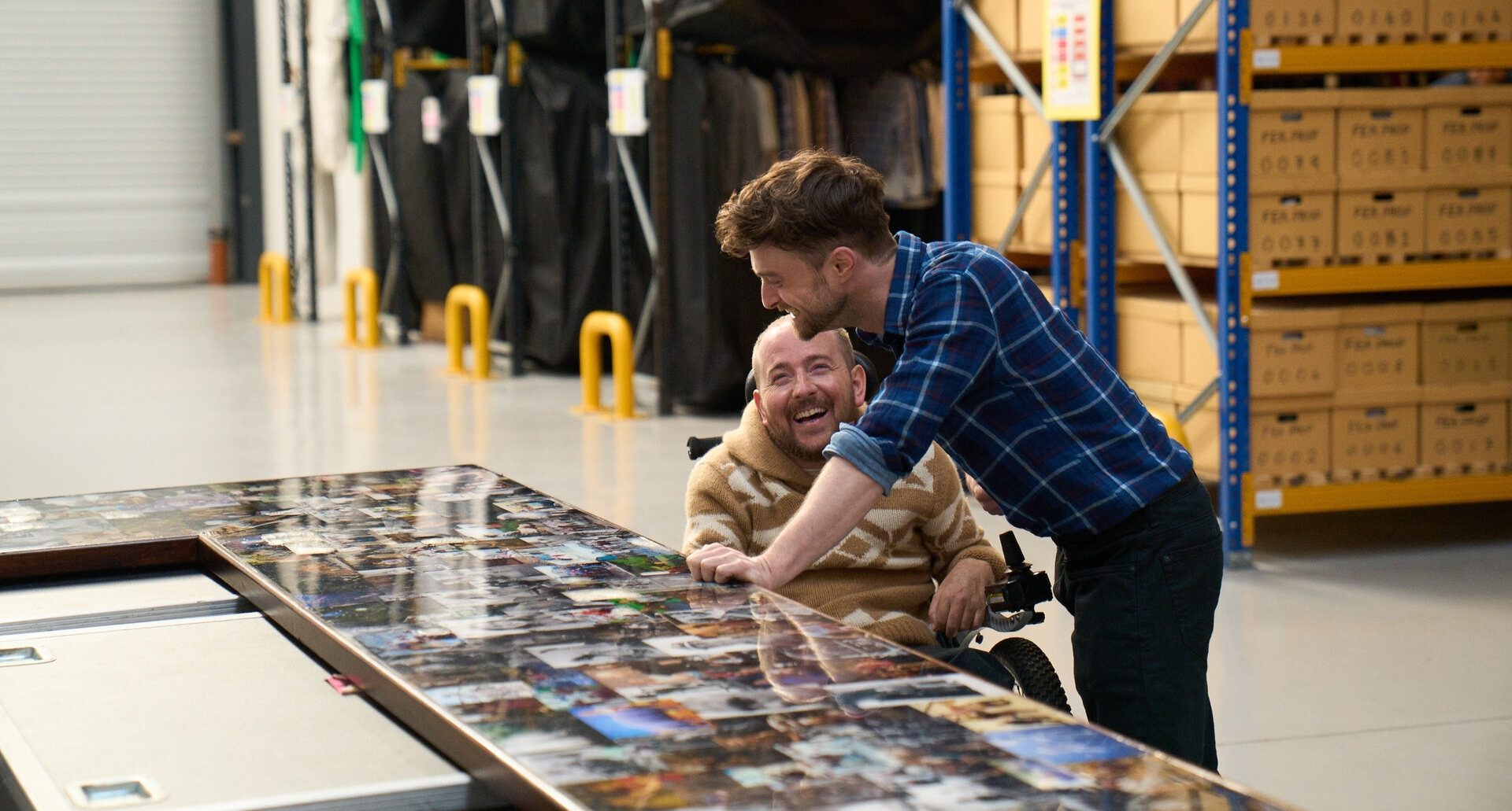 A man stands over a man in a wheelchair.