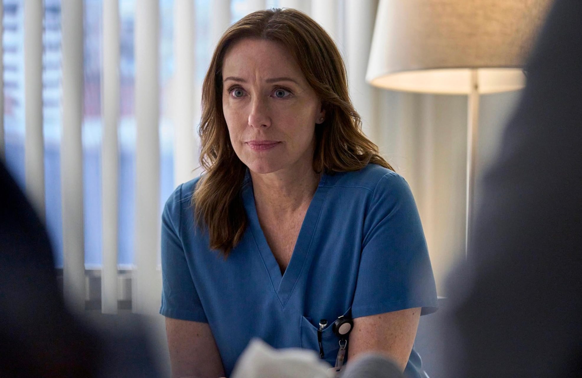 A female doctor leans in.