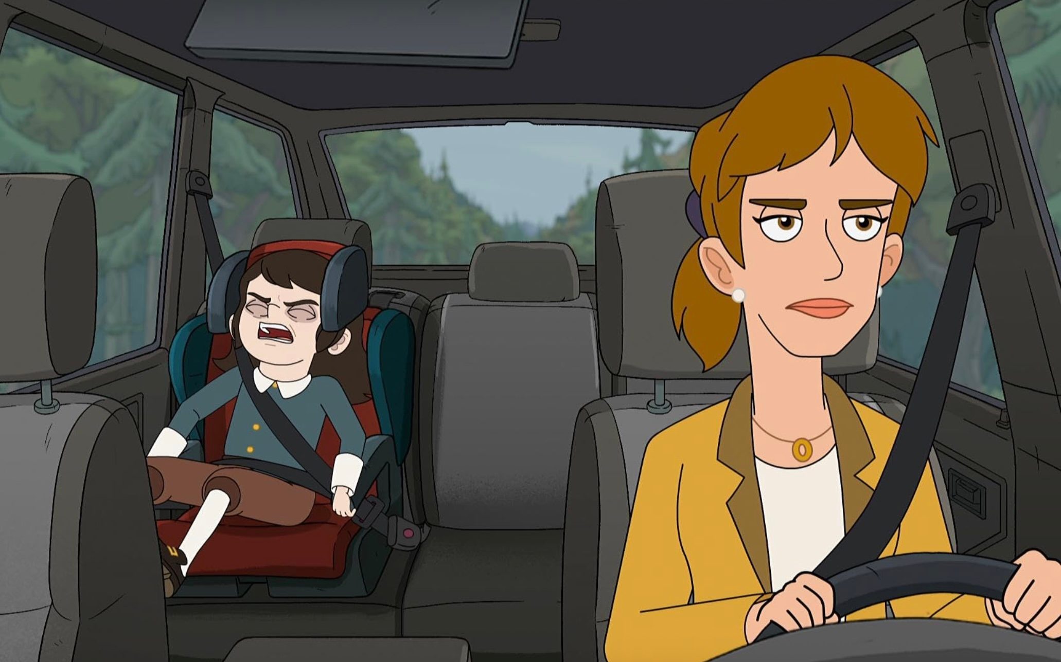 A woman sits in a chair with a boy in the back.