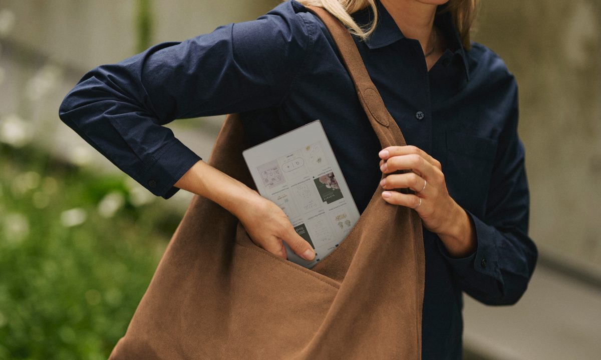A person slipping the Remarkable PAper Pro Move into their bag