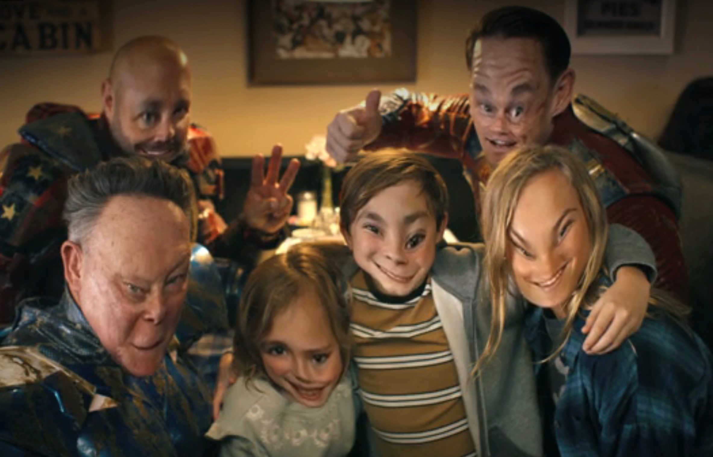 A melting photo of the Top Trio with three children in Peacemaker season 2.