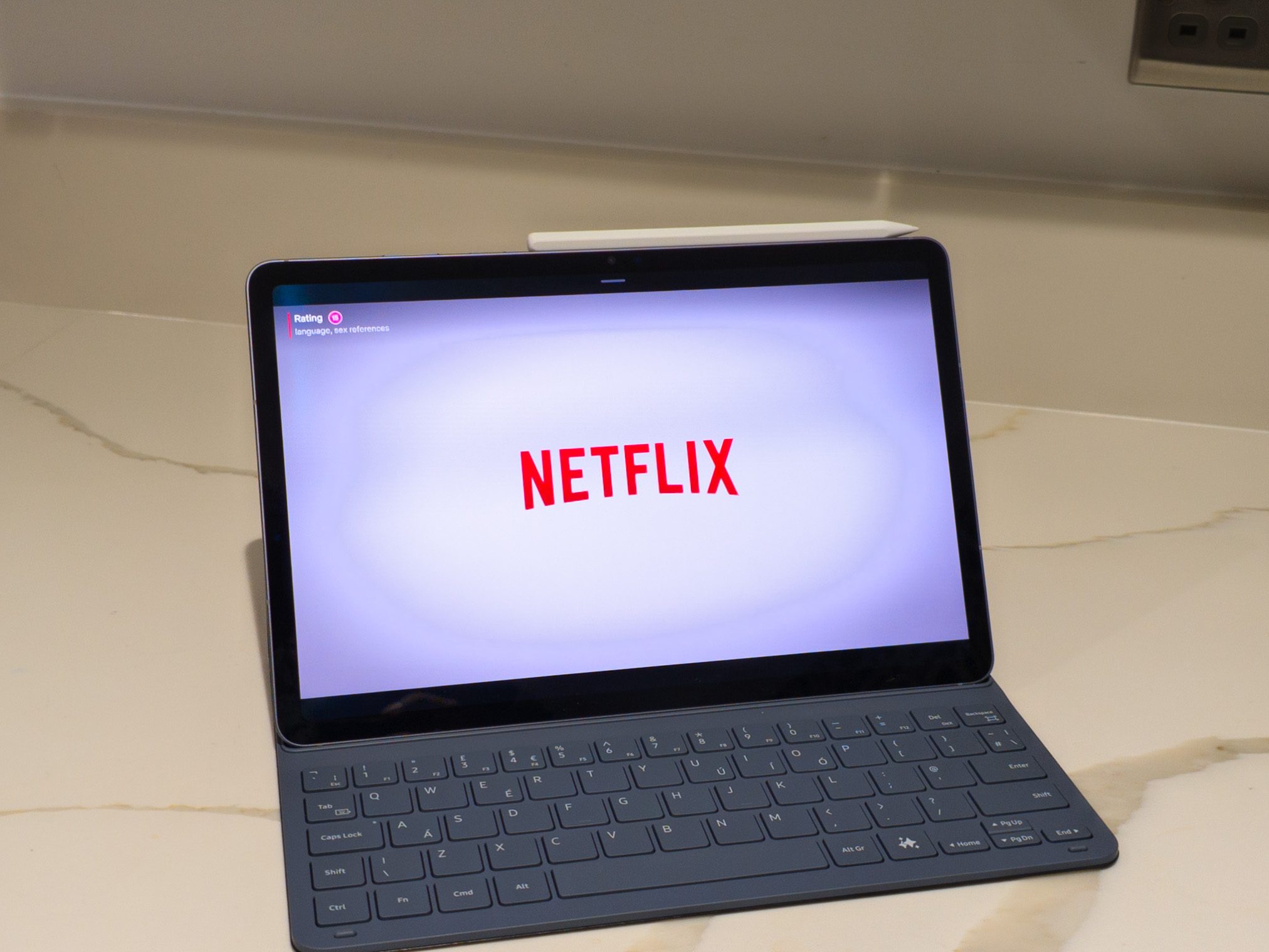 Netflix playing on the Galaxy Tab S11 in a kitchen with a slim keyboard cover attached