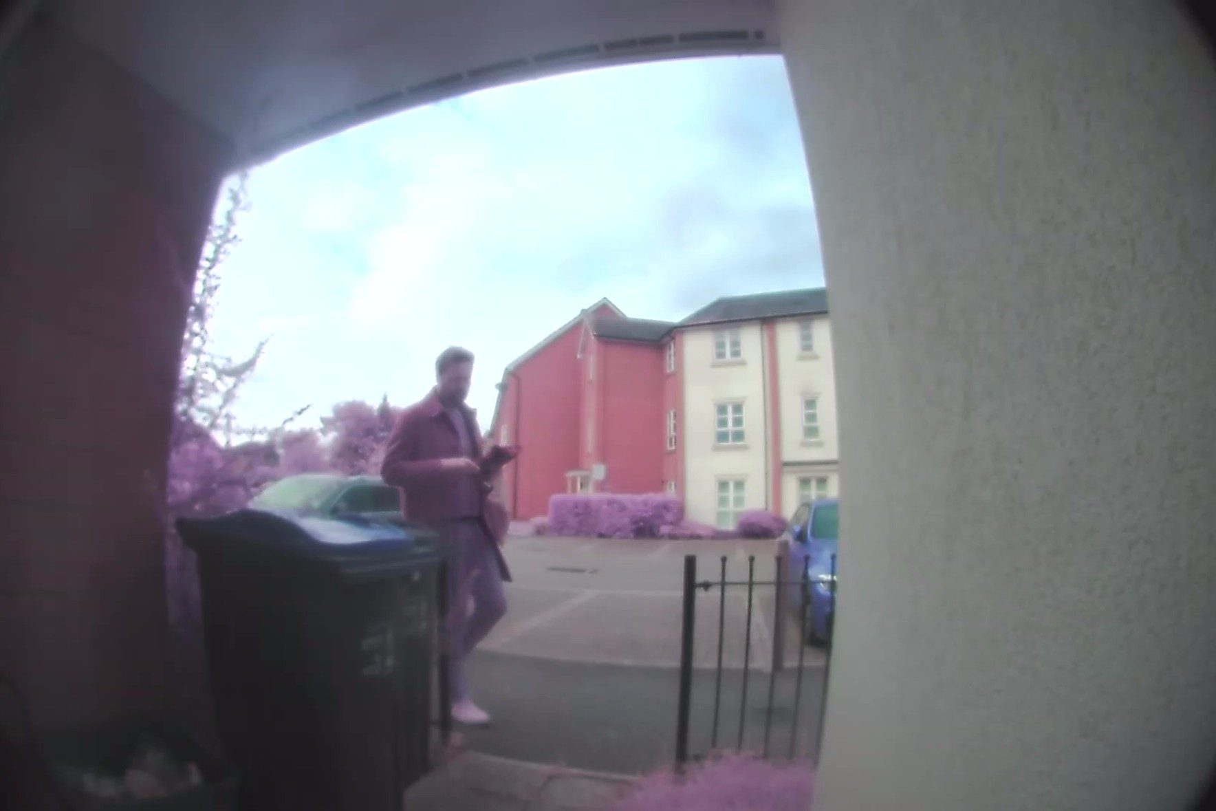 A man returning home, as viewed from his video doorbell.