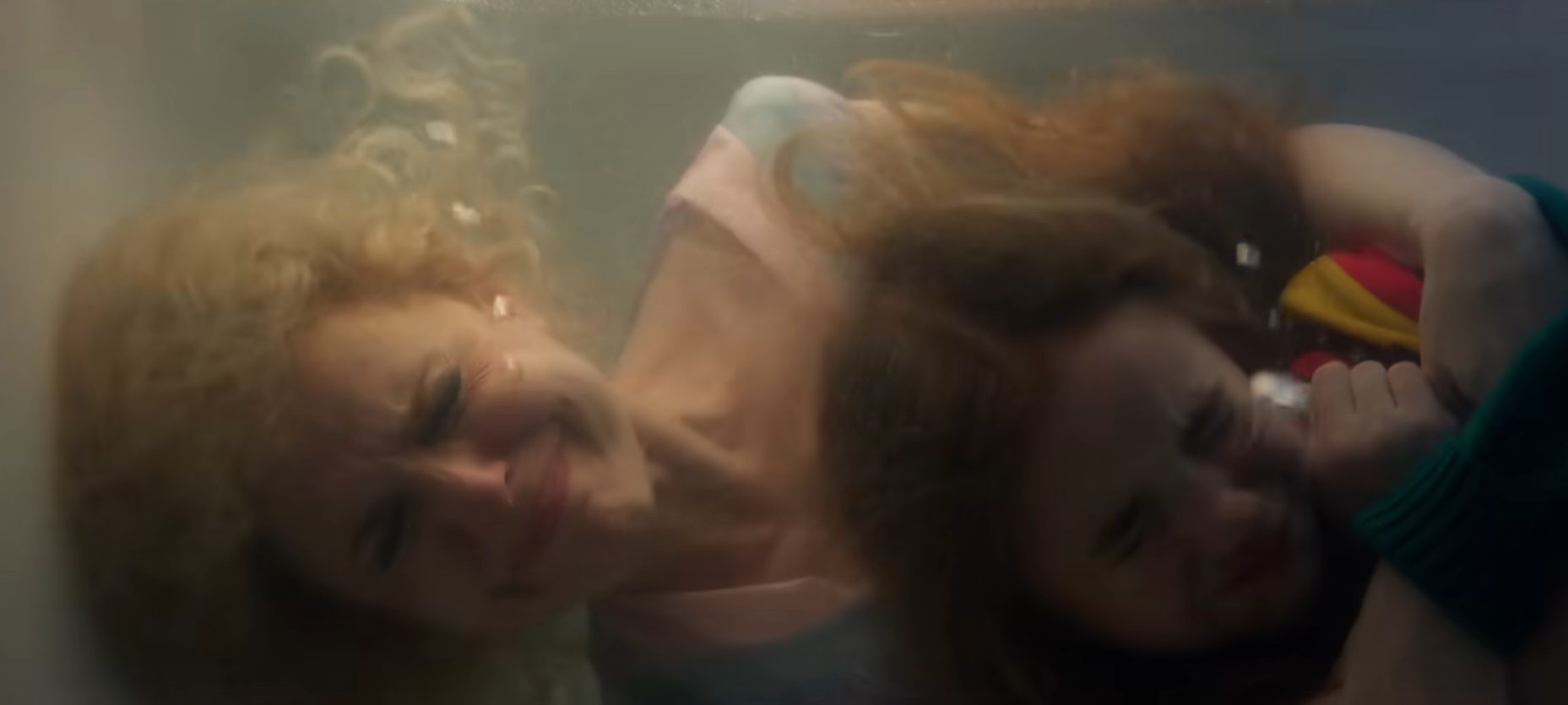 Karen and Holly hiding underwater in Stranger Things.